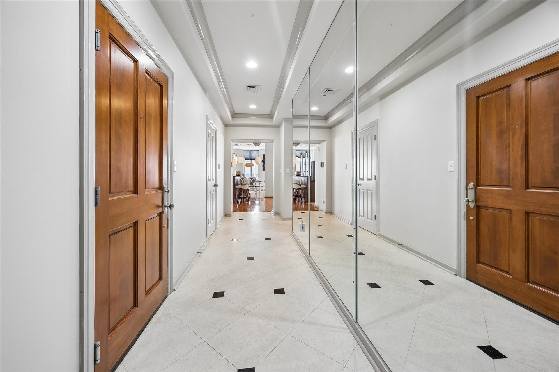 914 Main Street, #801, Houston, TX 77002 A grand entryway welcomes you with elegant tile flooring, mirrored walls, and rich wooden doors, leading seamlessly into the heart of the home.