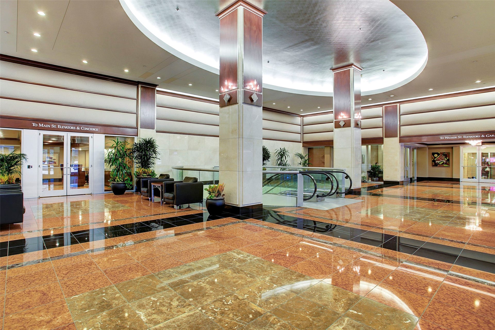 914 Main Street, #801, Houston, TX 77002 Elegant and spacious lobby with polished marble floors, modern lighting, and comfortable seating areas, perfect for welcoming guests.