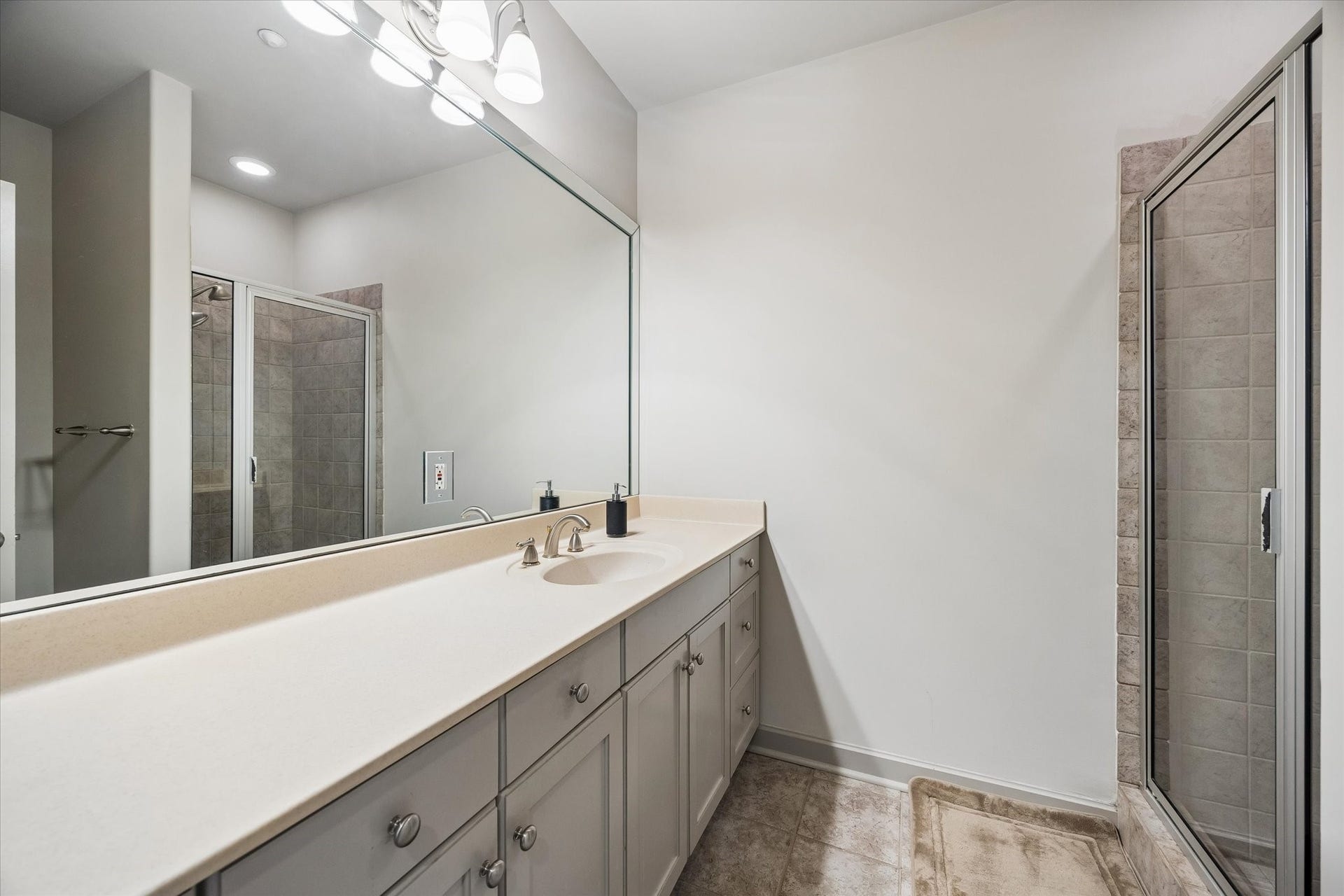 914 Main Street, #801, Houston, TX 77002 Spacious bathroom featuring a large vanity with ample storage, elegant fixtures, and a sleek, glass-enclosed shower.