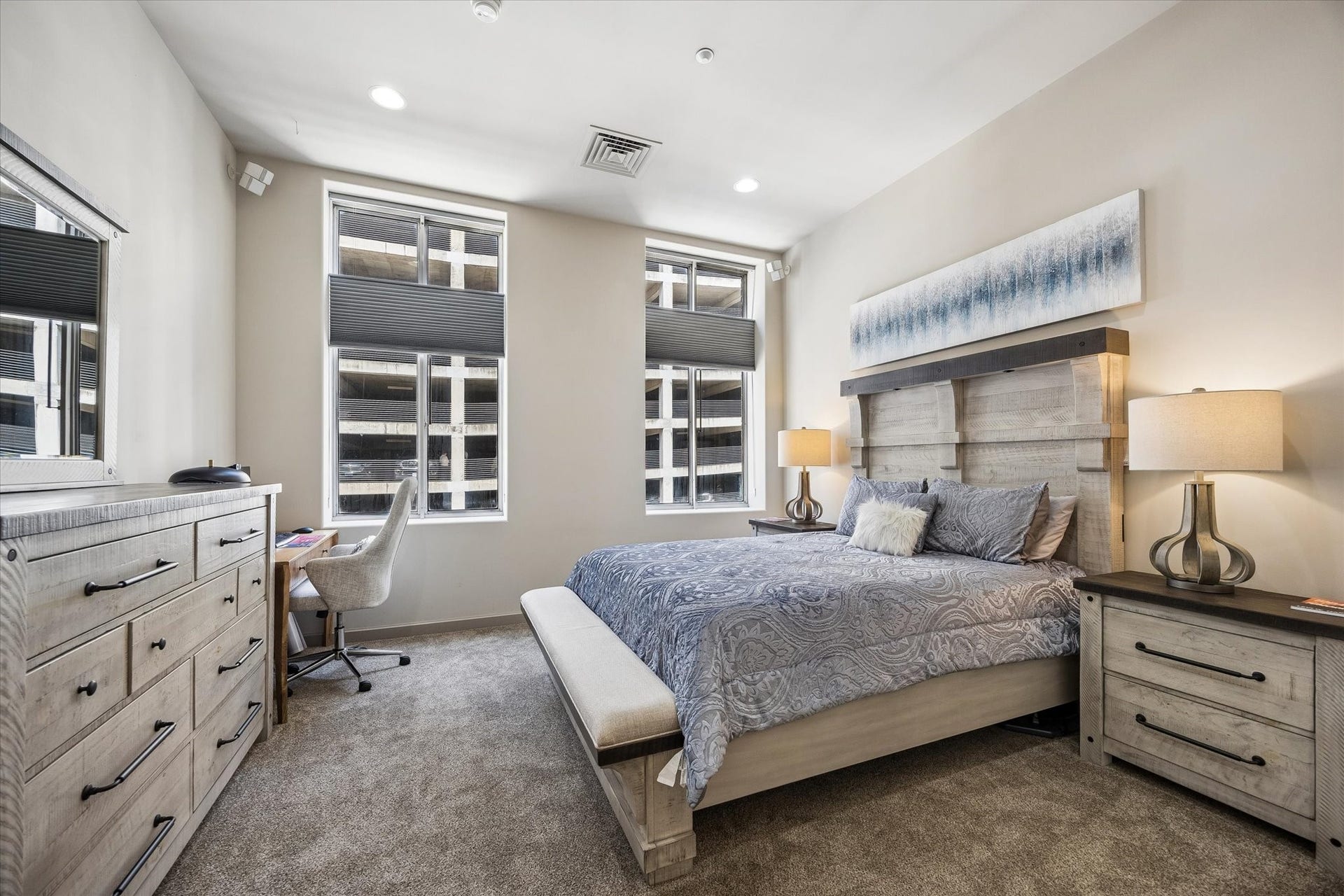 914 Main Street, #801, Houston, TX 77002 Spacious bedroom with large windows, stylish furnishings, and ample natural light, creating a cozy and inviting atmosphere.