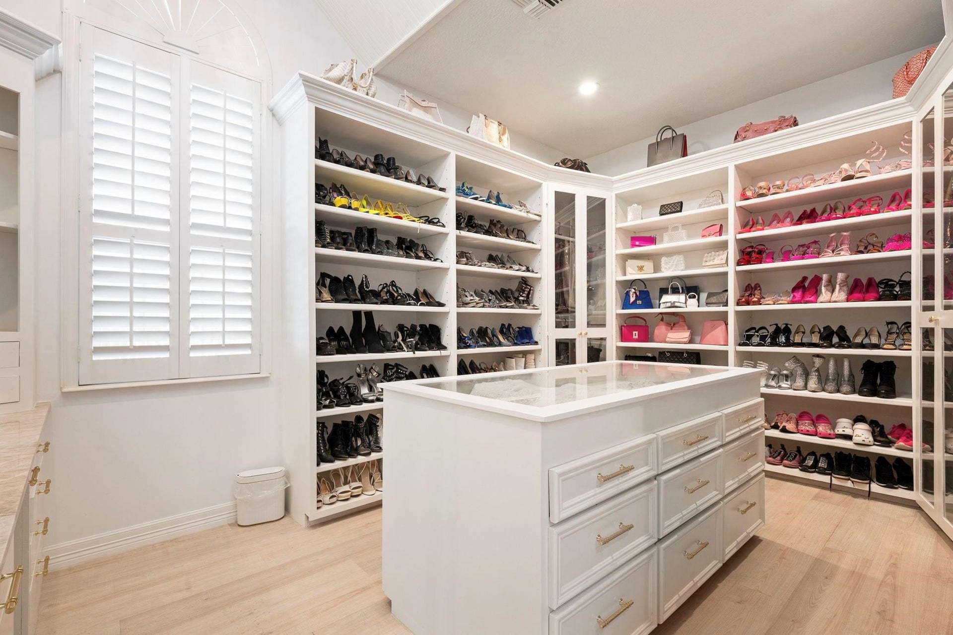 2922 Cedar Woods Place, Houston, TX 77068 The Primary Closet is truly a dreamfeaturing a center island, expansive storage, and custom shelving designed for shoes and handbags.