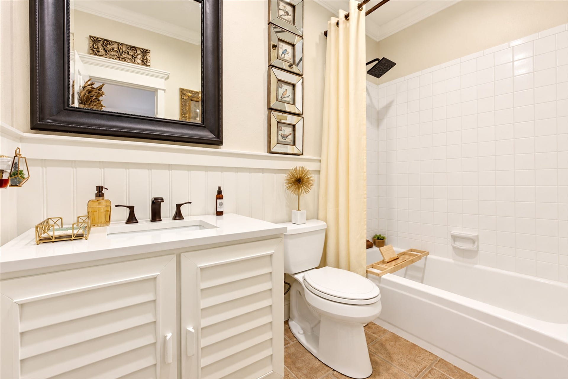 6839 Hertford Park Drive, Houston, TX 77084 The updated secondary bathroom features a white vanity, dark fixtures and a tub/shower combination.