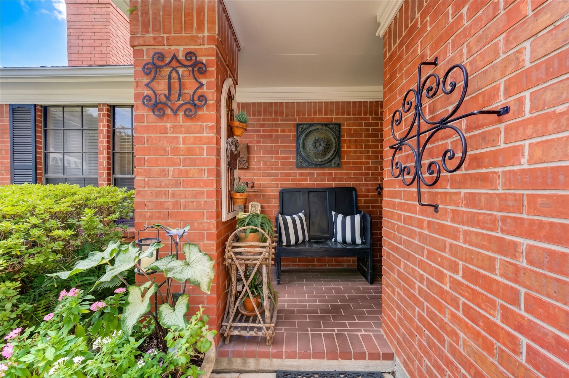 6839 Hertford Park Drive, Houston, TX 77084 A charming covered front porch offers a comfortable spot to sit and enjoy the garden.