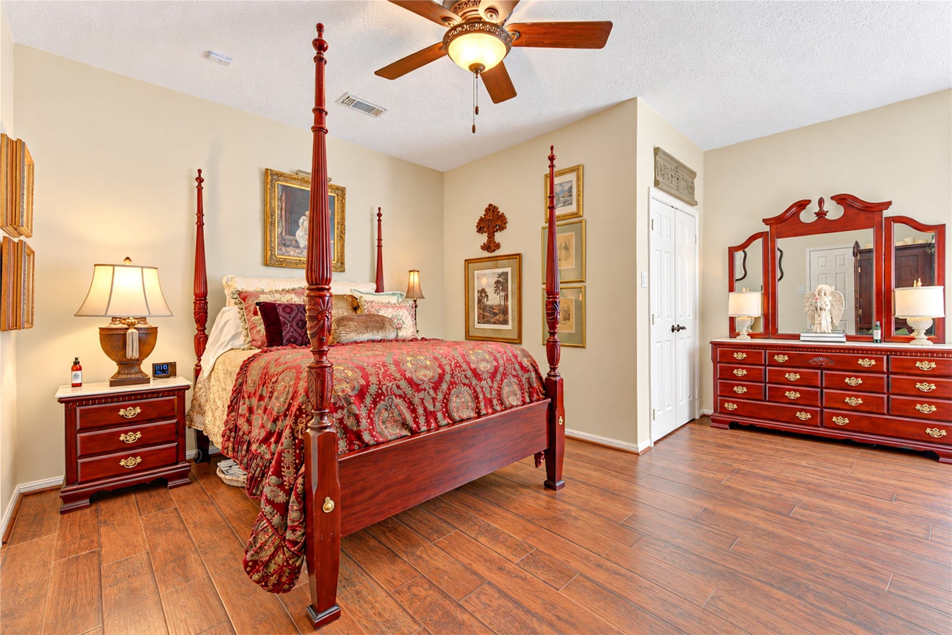 6839 Hertford Park Drive, Houston, TX 77084 The spacious primary bedroom offers warm flooring, a ceiling fan and access to its private bath.