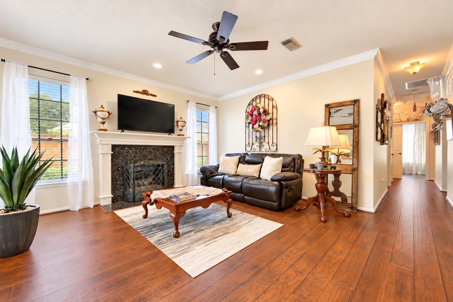 6839 Hertford Park Drive, Houston, TX 77084 Natural light and a fireplace create a comfortable setting for everyday living.