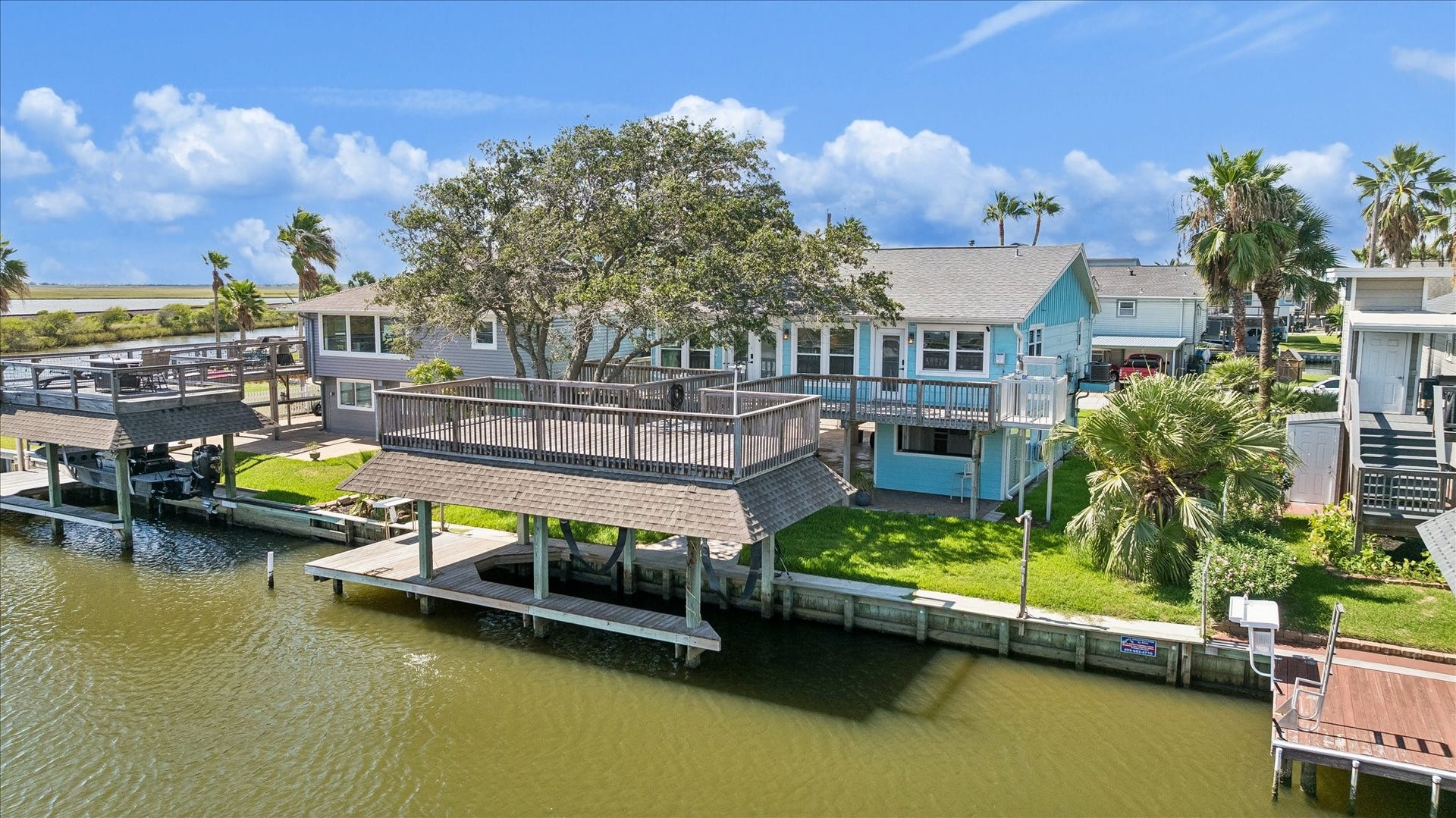 853 Marlin Street, Bayou Vista, TX 77563 Beautiful waterfront home with spacious decks, lush landscaping, and direct canal access, perfect for boating enthusiasts and outdoor relaxation.