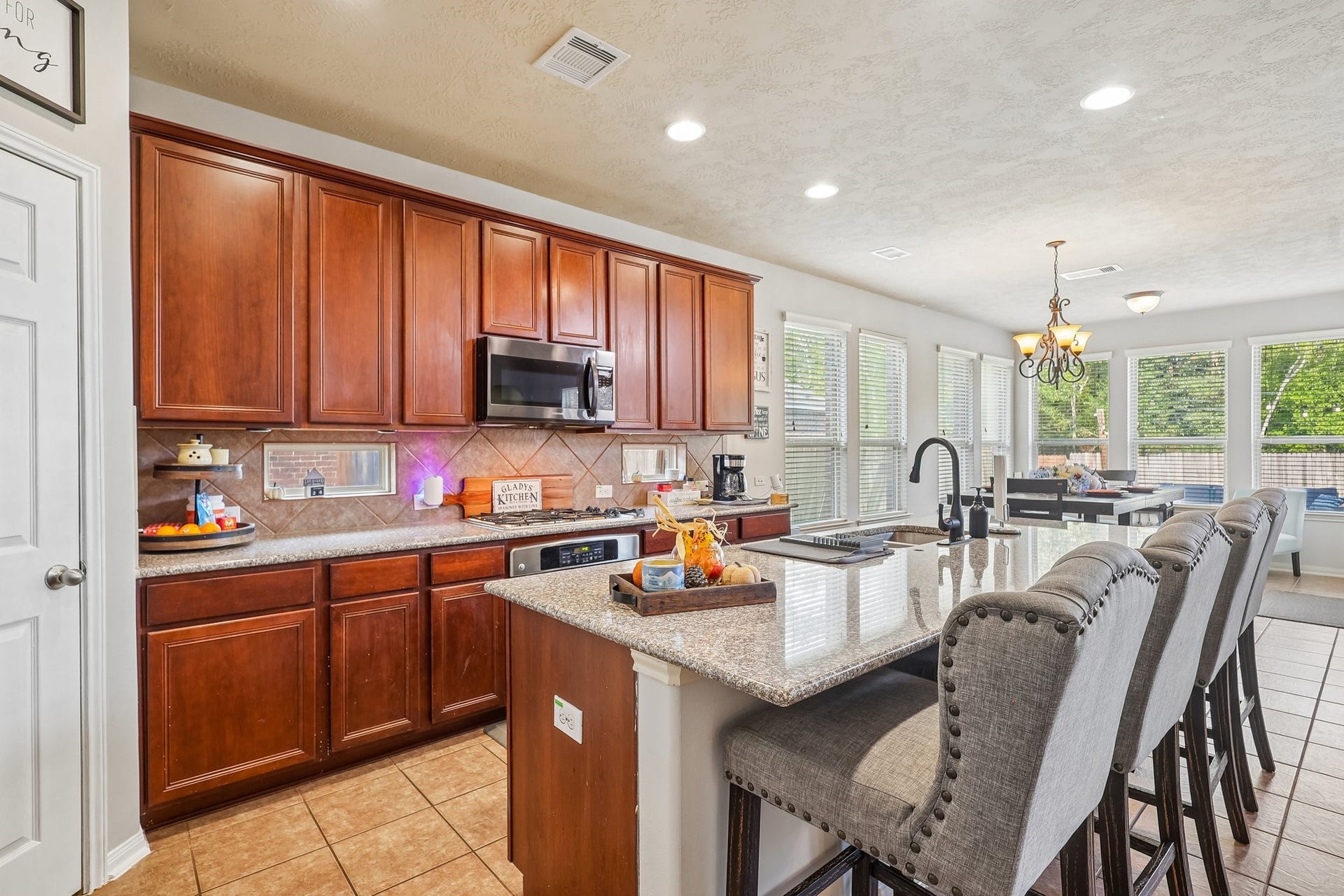 4731 Maple Creek Drive, Fresno, TX 77545 Granite counters, gas cooktop, and a wine rack waiting on Friday