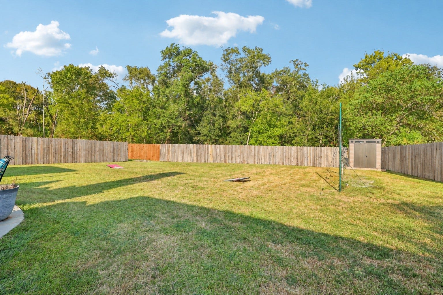 4731 Maple Creek Drive, Fresno, TX 77545 A fully fenced backyard with trees behind it instead of neighbors. Virtually staged