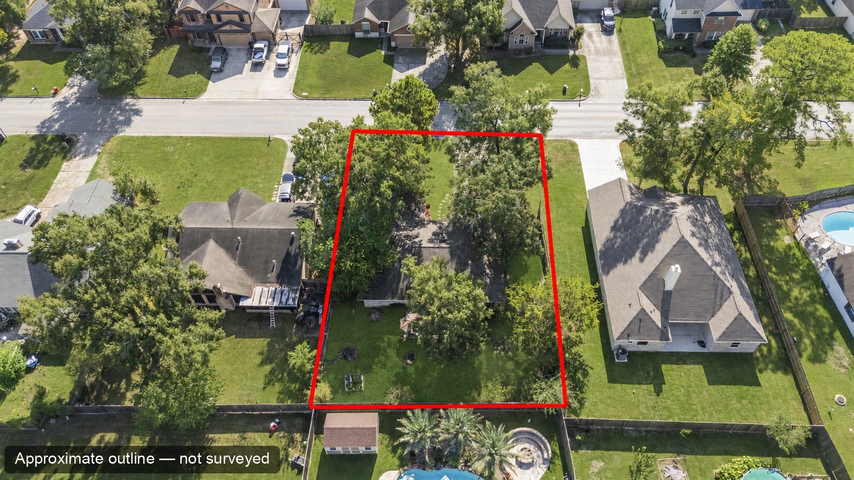Overhead aerial of the home and surrounding properties. The red outline is approximate, for location only, and is not a surveyed boundary.