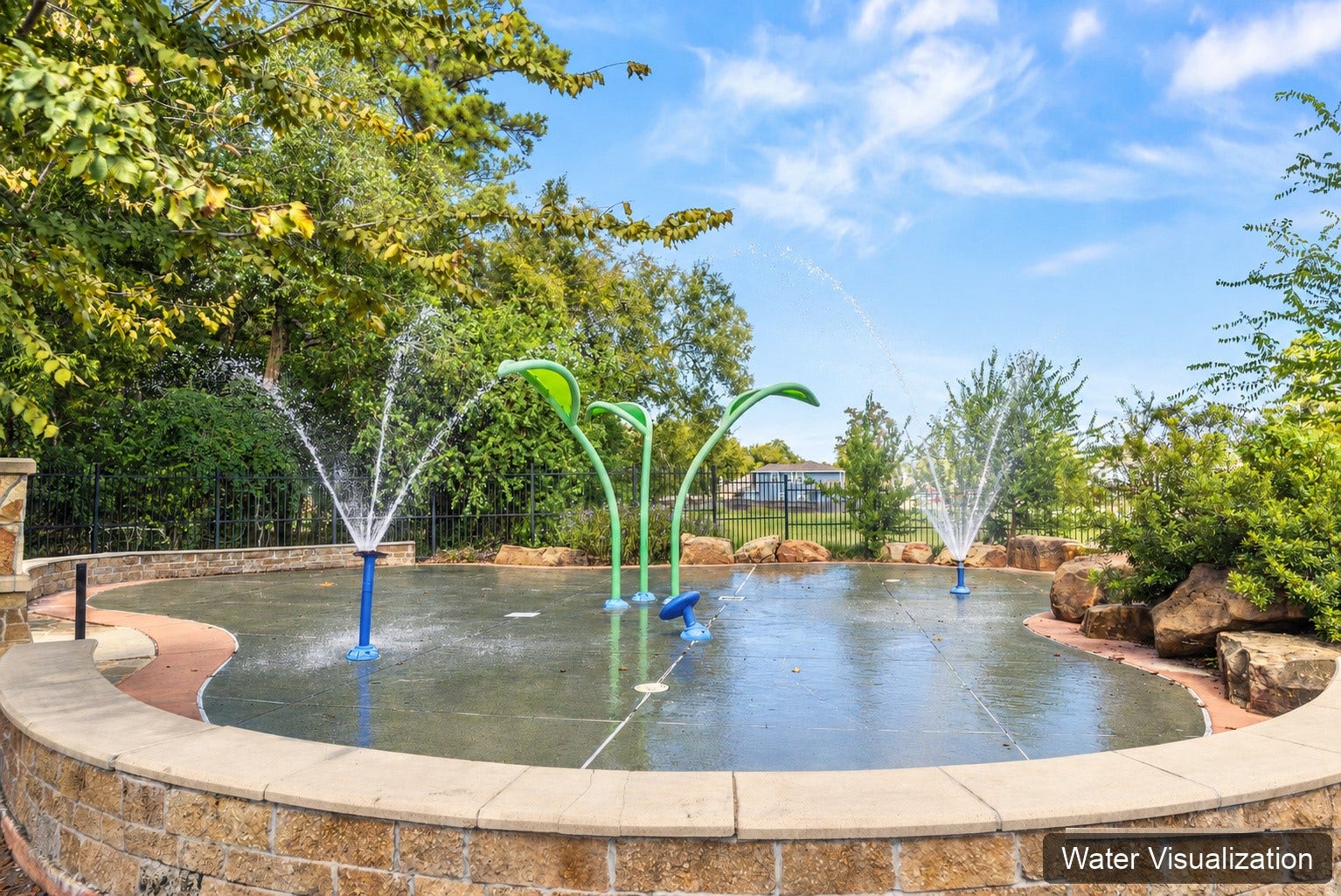 Community splash pad surrounded by landscaping and seating. Water spray has been digitally added for visualization.