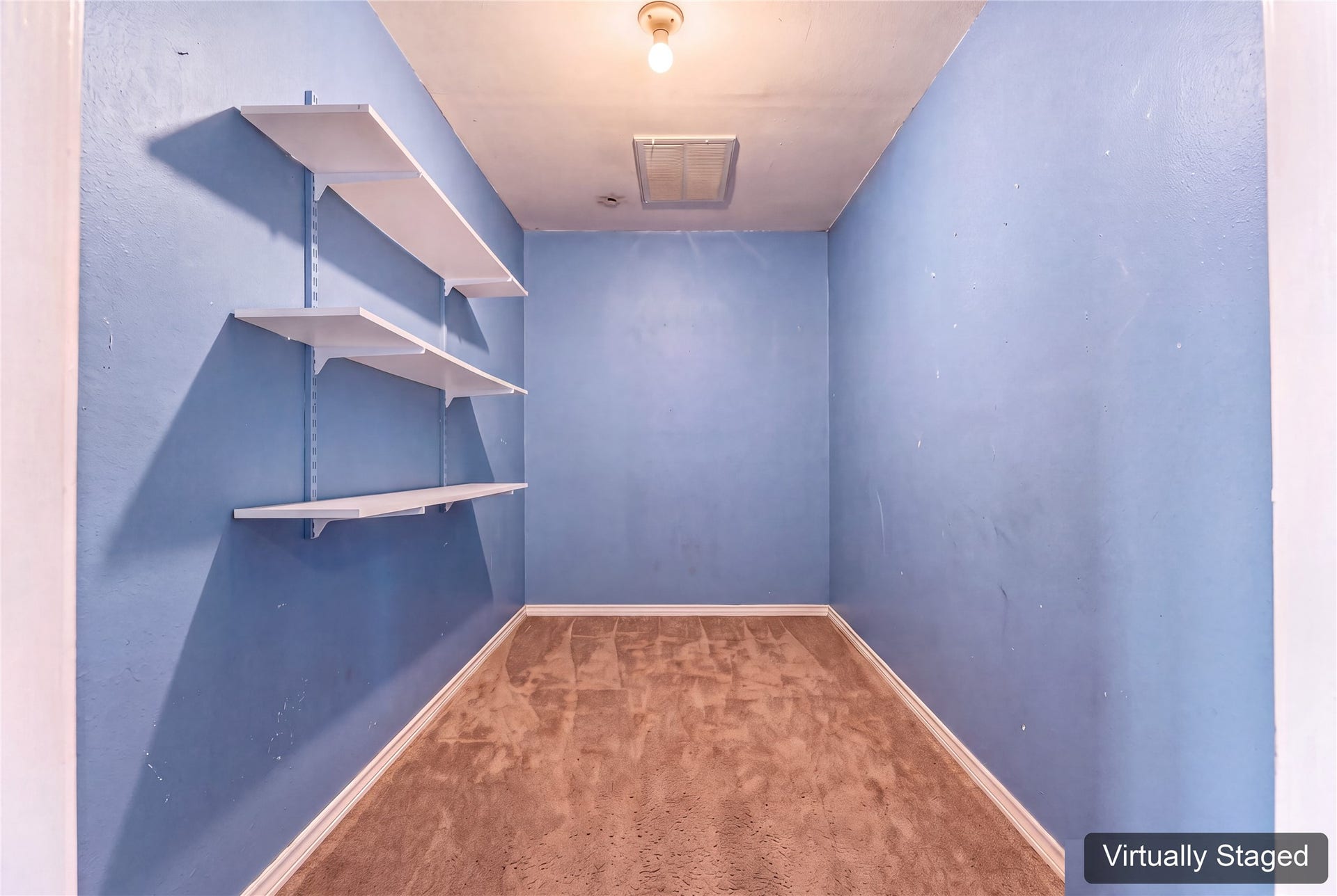 Virtually cleared bonus storage room inside the garage, connected to the home's HVAC. A useful conditioned space for extra pantry supplies, seasonal items, or belongings you prefer to keep out of garage heat. Original photo at the end shows the existing contents.