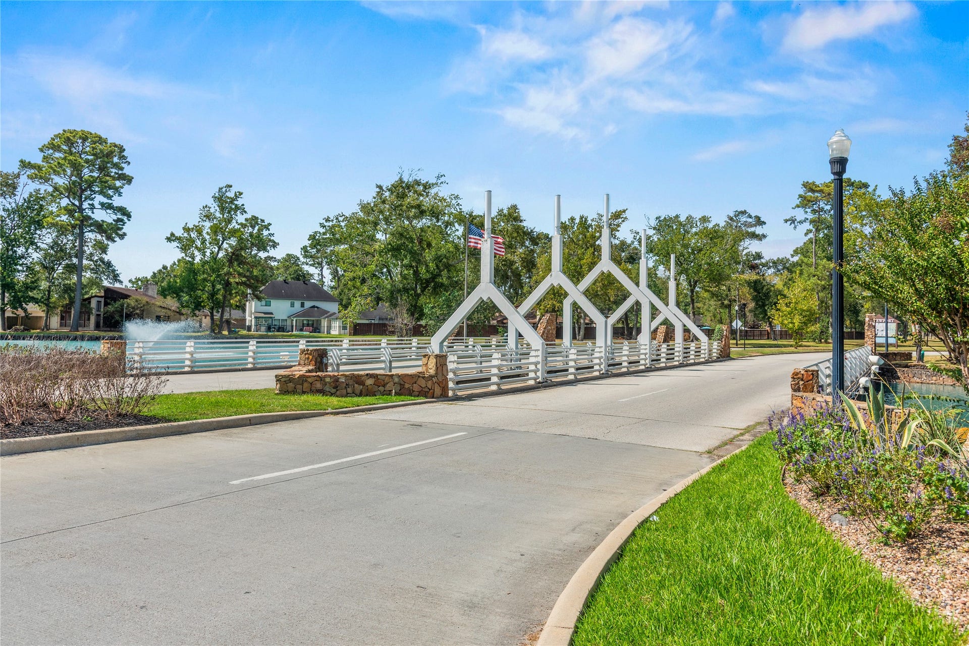Newport community entrance with landscaped grounds and a view along the entrance road.