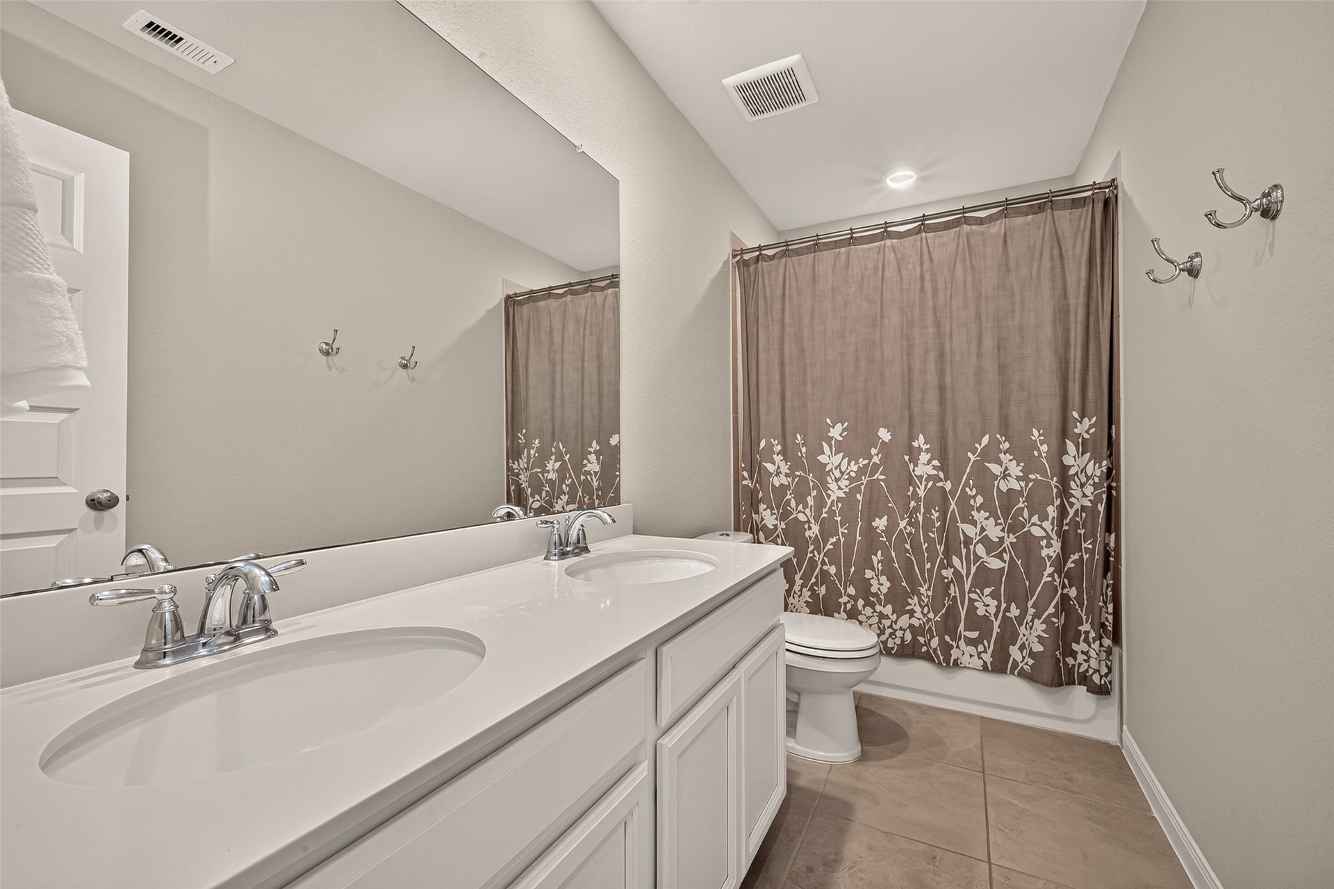 2321 W Winding Pines Drive, Tomball, TX 77375 Nice bathroom featuring double sinks and a tub/shower combination located upstairs.