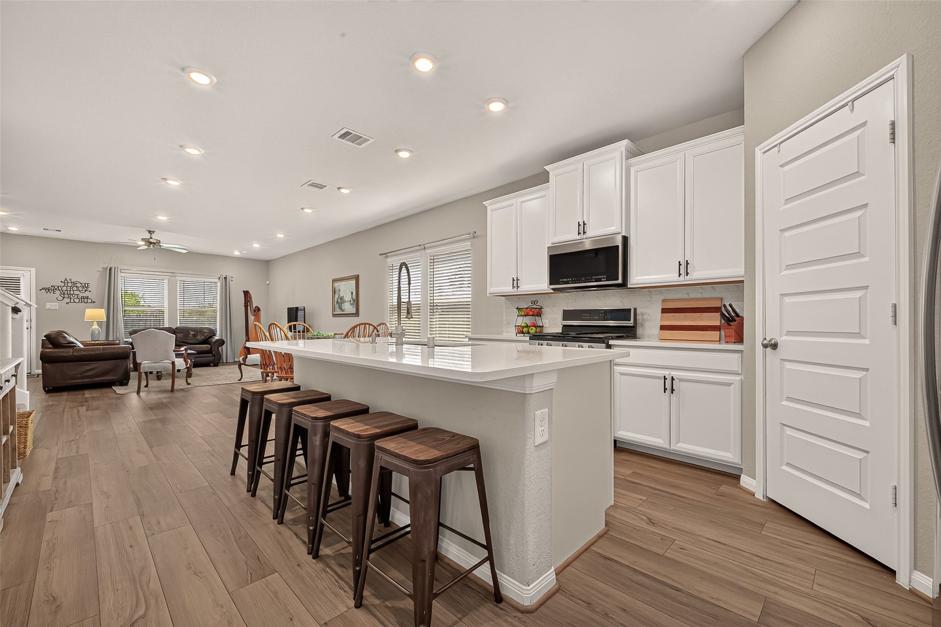 2321 W Winding Pines Drive, Tomball, TX 77375 Beautiful white cabinets with white quartz countertops greet you in the kitchen.