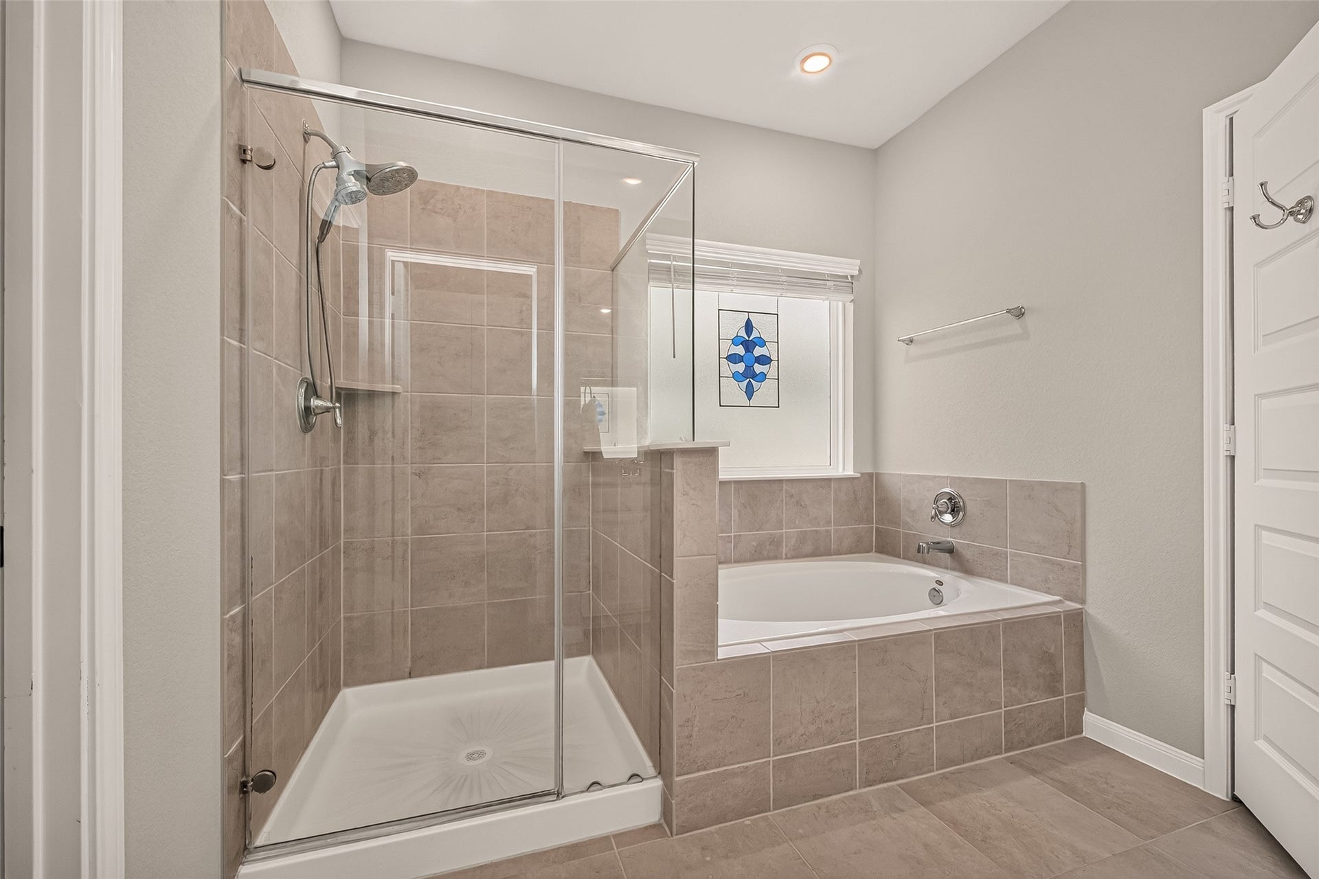 2321 W Winding Pines Drive, Tomball, TX 77375 Beautiful tile work and plenty of light in this primary bathroom.