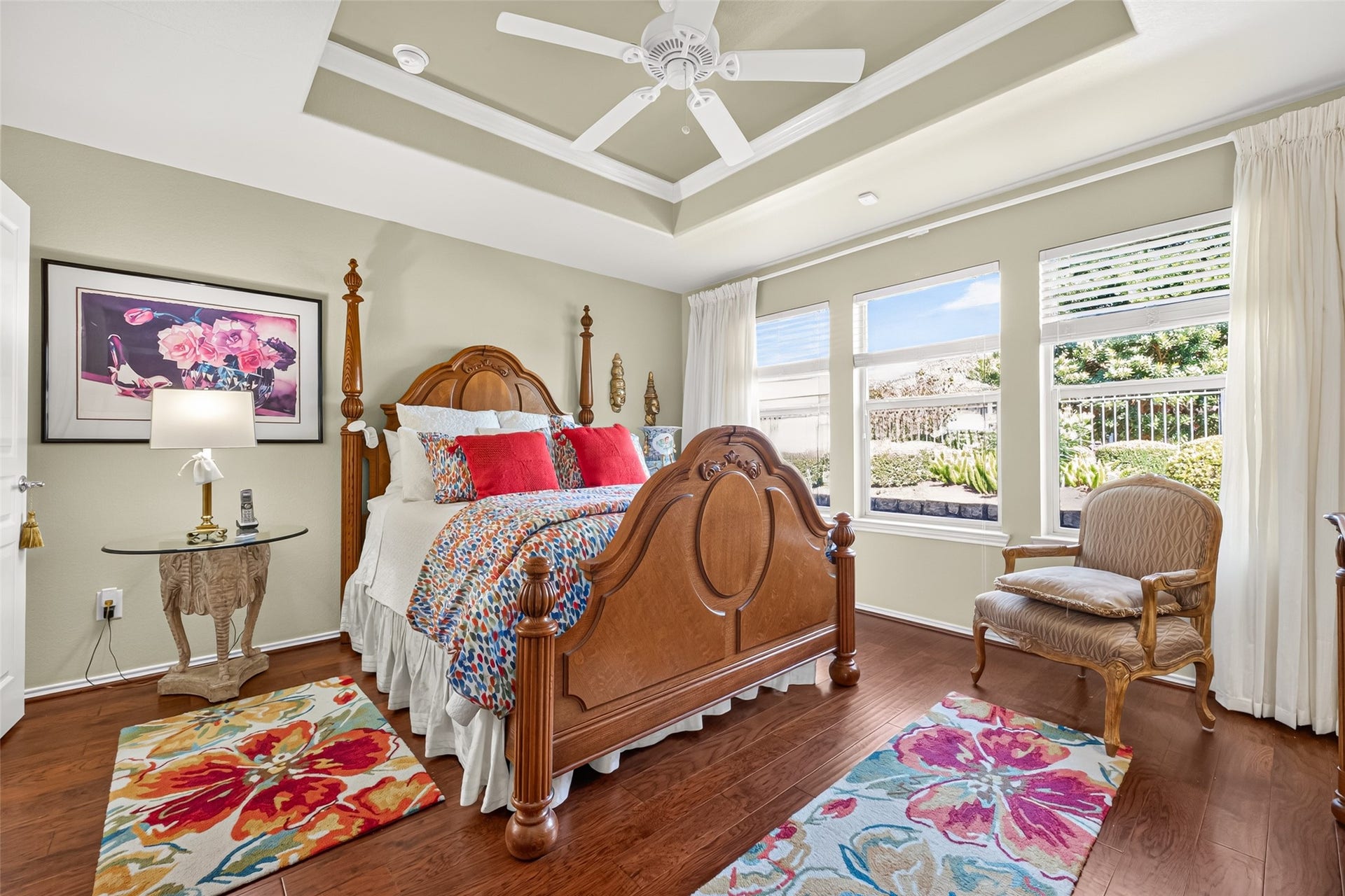 1126 Oleander Way, Richmond, TX 77469 A restful primary bedroom with hardwood floors and a distinctive tray ceiling.