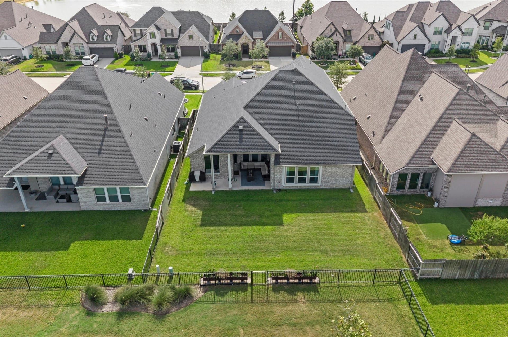 Drone view of the home and backyard. There is a gate for quick access to the walking path from your backyard.