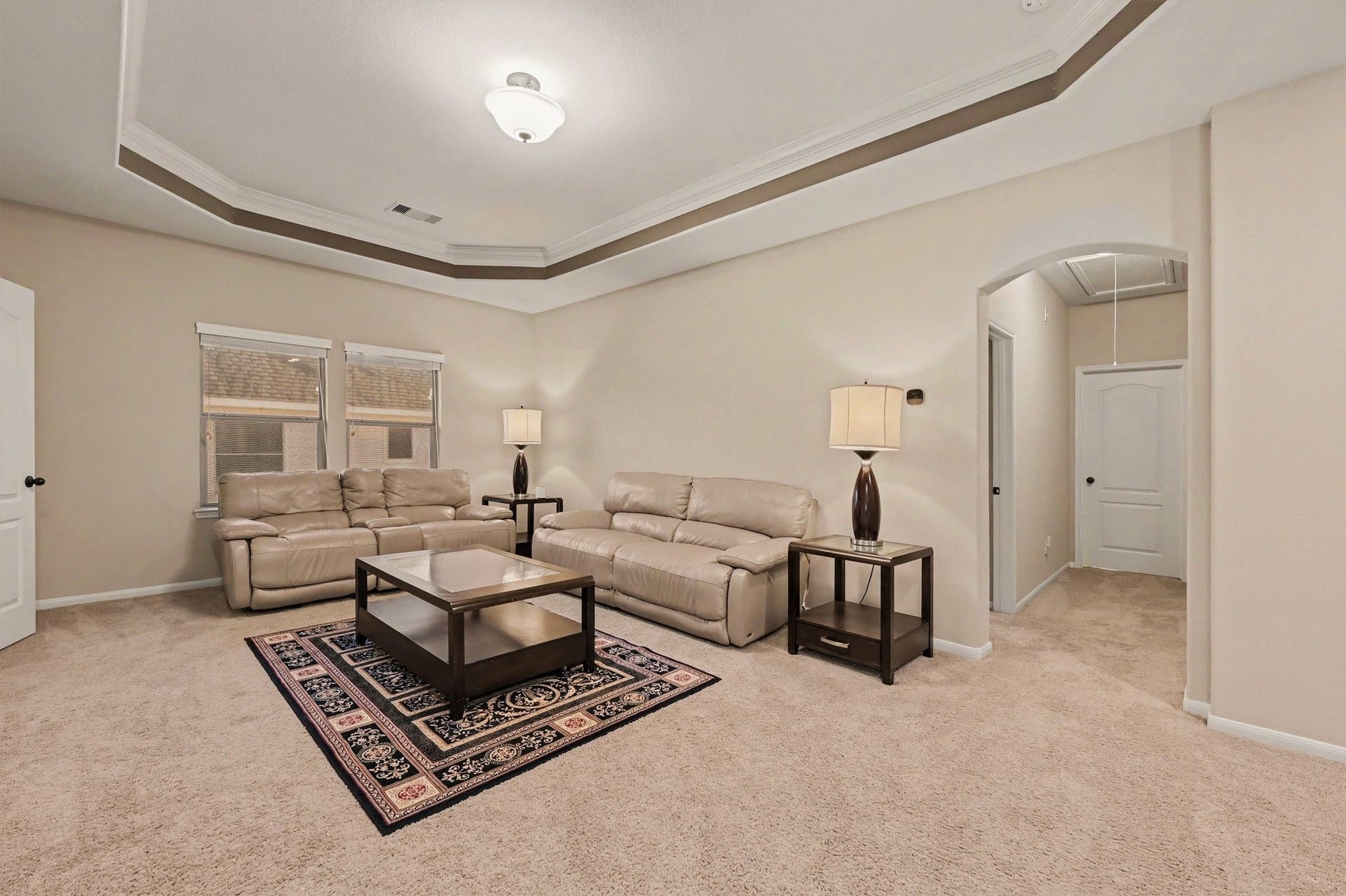 6410 Archer Ranch Lane, Rosenberg, TX 77471 Spacious upstairs family room with an elegant tray ceiling, offering a comfortable space to relax or entertain.