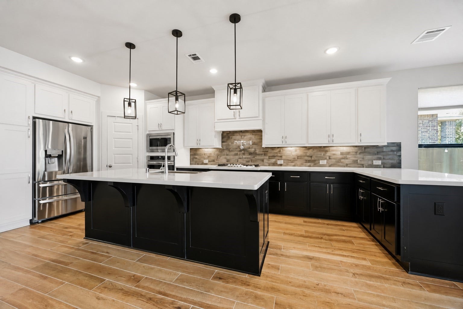 6718 Waxbill Road, Katy, TX 77493 This stunning chefs kitchen features elegant cabinetry, under cabinet lighting, tons of storage space, a pot filler, and a spacious pantry.