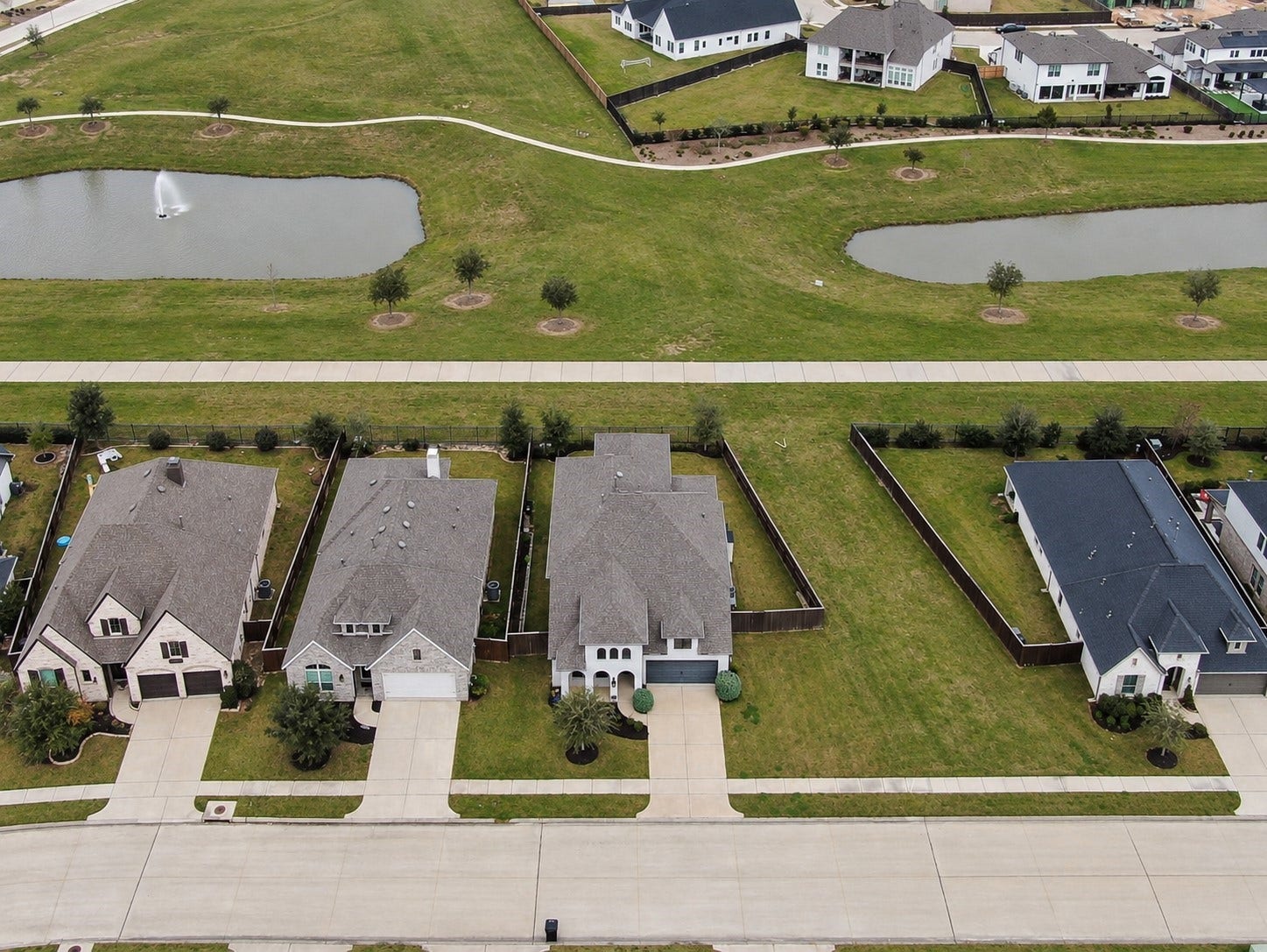 6718 Waxbill Road, Katy, TX 77493 This sweeping aerial shot highlights this exceptional lot with NO back neighbors, direct access to community walking trails, and a scenic view of the community lakes.
