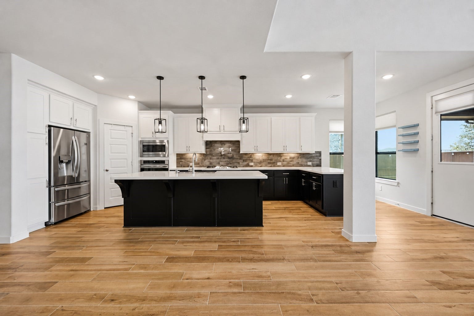 6718 Waxbill Road, Katy, TX 77493 The kitchen boasts a deco wood paneled island with sleek pendant lighting and extended peninsula for extra countertop space. Upgraded with built-in stainless steel appliances, a 5 burner gas cooktop, and contrasting cabinets, this kitchen is ideal for cooking for the whole family or hosting holidays!