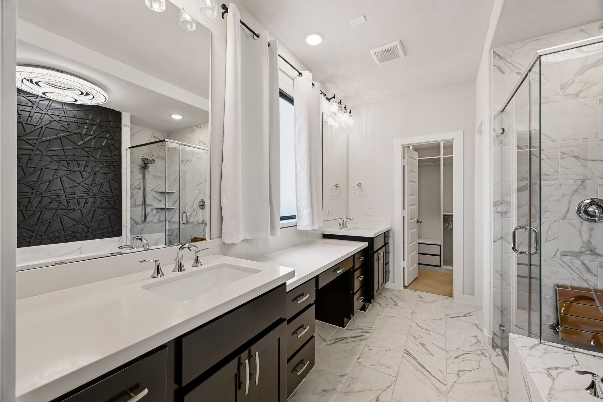 6718 Waxbill Road, Katy, TX 77493 You'll love getting ready in this light and bright primary bathroom! The primary bathroom includes a large vanity with dual sinks, make-up counter, quartz countertops, and a window letting in bright natural light!