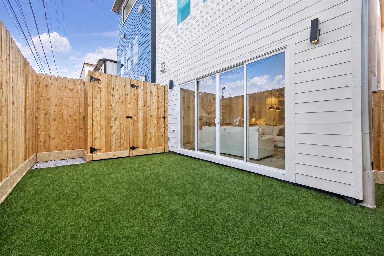 2204 Huldy Street, Houston, TX 77019 Private, fully fenced backyard features low-maintenance artificial turf & convenient access through expansive sliding glass doors from the family room. Wonderful outdoor space for lounging, grilling, entertaining or pets to play! Enjoy the ease of low-maintenance living in the heart of the desirable River Oaks Shopping Center Area.