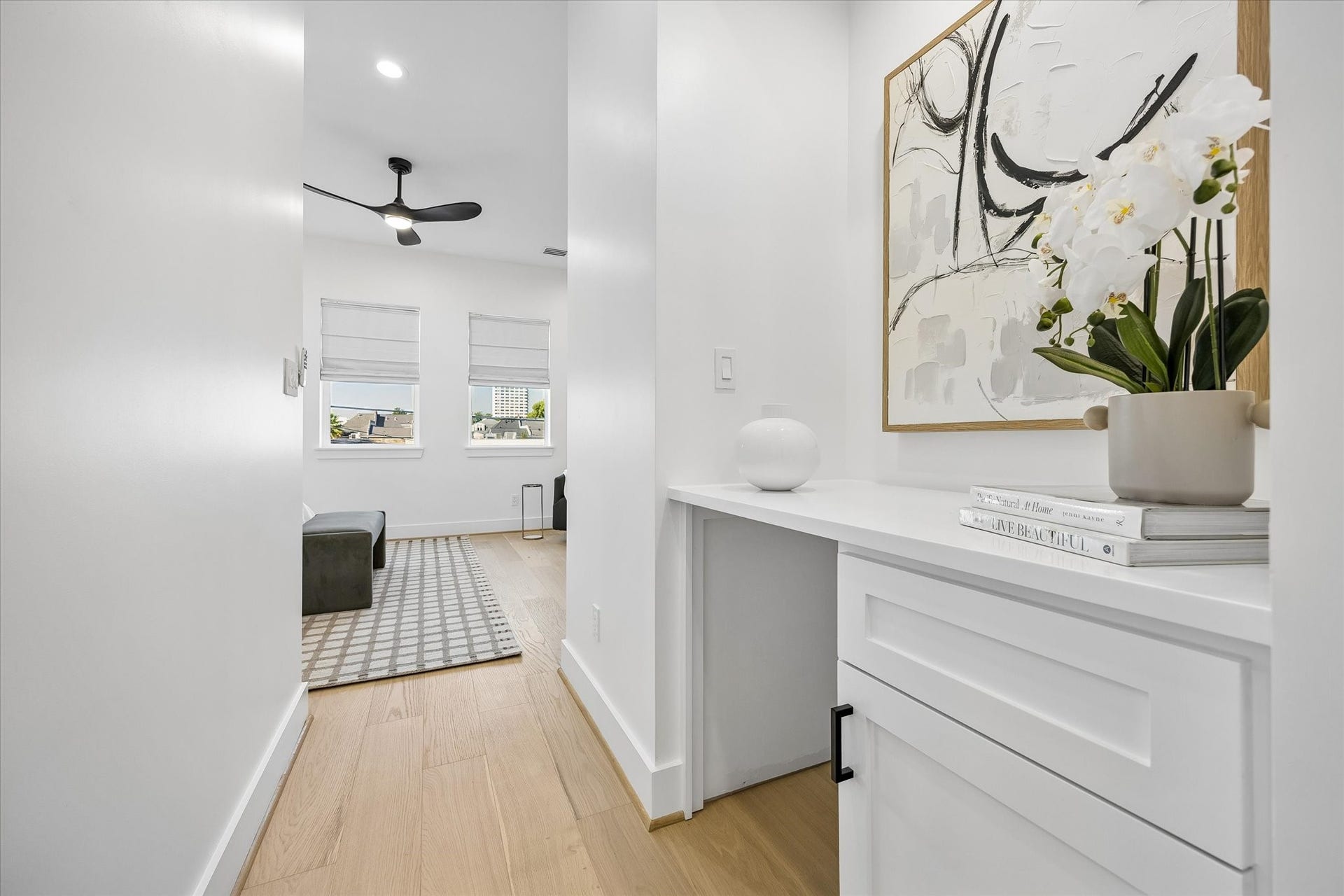 2204 Huldy Street, Houston, TX 77019 Upon entering the primary suite is a built-in desk/counter area with cabinetry offers additional functionality, with plumbing available for a potential beverage refrigerator or sink; makes an ideal coffee bar!