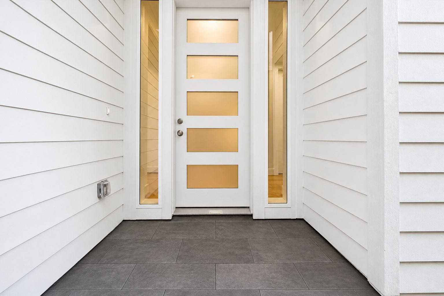 2204 Huldy Street, Houston, TX 77019 Welcoming side private entry features a gravel walkway w/ pavers (not shown) leading to the front door. Beautiful exterior hardie siding (no stucco!), low-maintenance landscaping & private driveway make this home ideal for effortless everyday living!