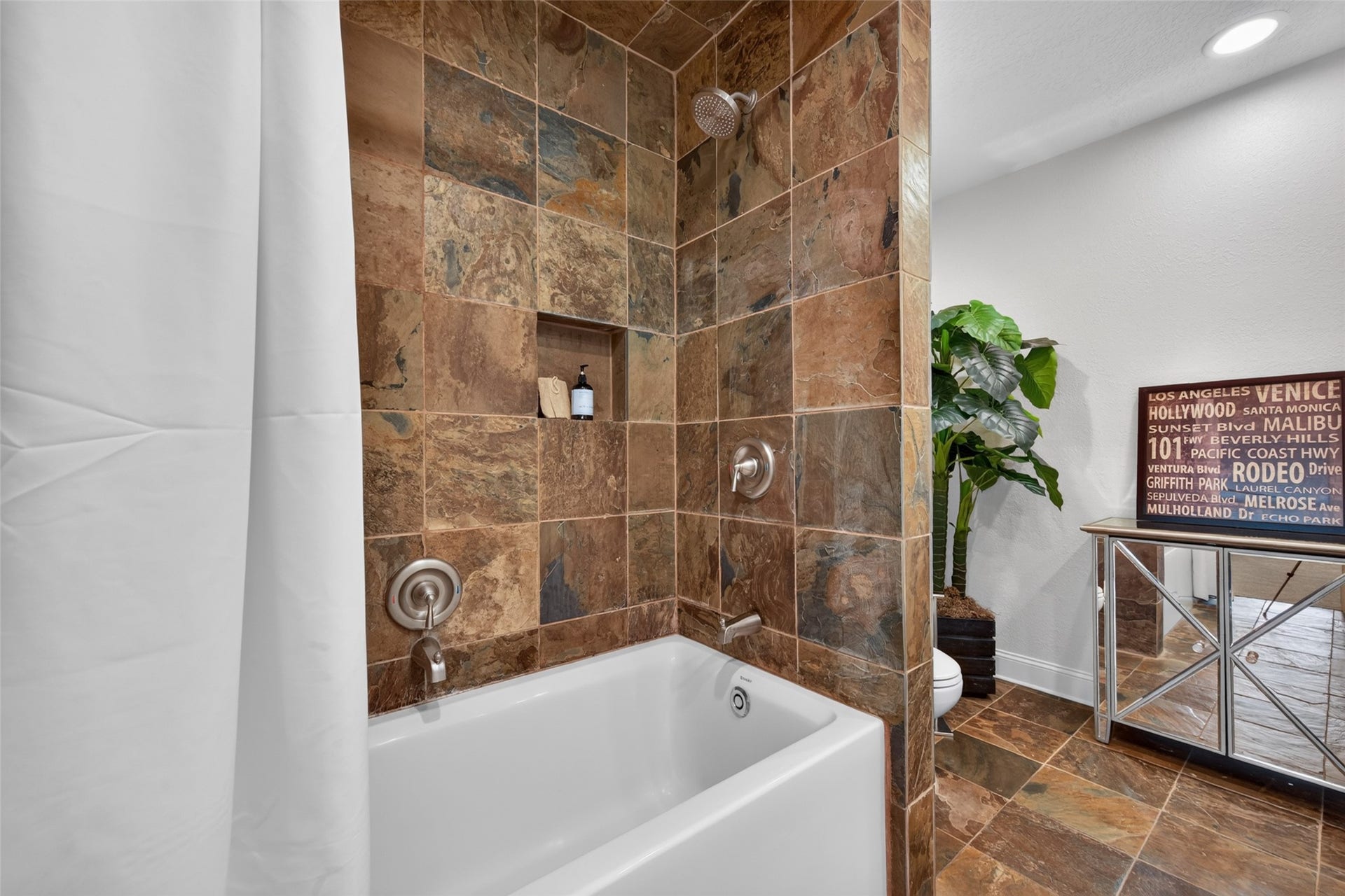 8906 Seber Drive, Tomball, TX 77375 Secondary bath features a tub/shower combination with tile surround, creating a comfortable and functional space for family or guests.