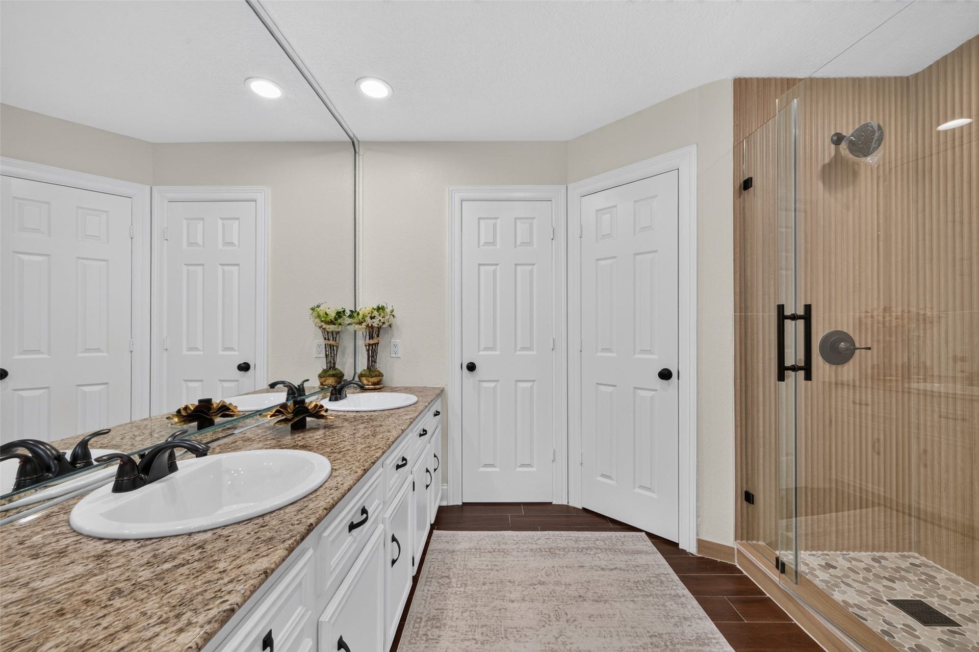 8906 Seber Drive, Tomball, TX 77375 Primary ensuite features a long dual-sink vanity, granite countertop and beautifully updated walk-in shower.