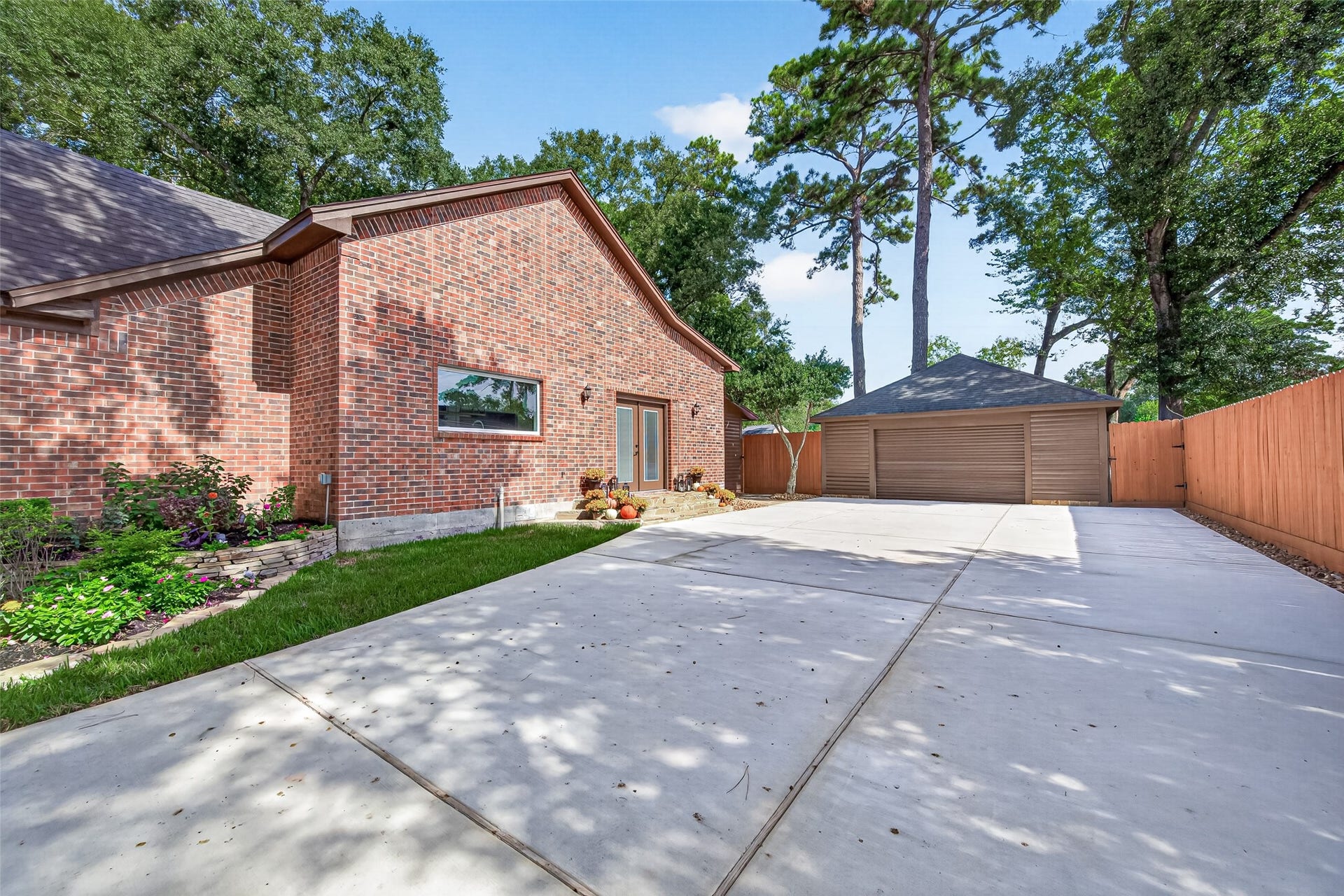 8906 Seber Drive, Tomball, TX 77375 From this side of the home, the driveway continues to the detached garage and convenient side entrance, providing direct access into the kitchen areaperfect for bringing in groceries without having to go through the front of the home.