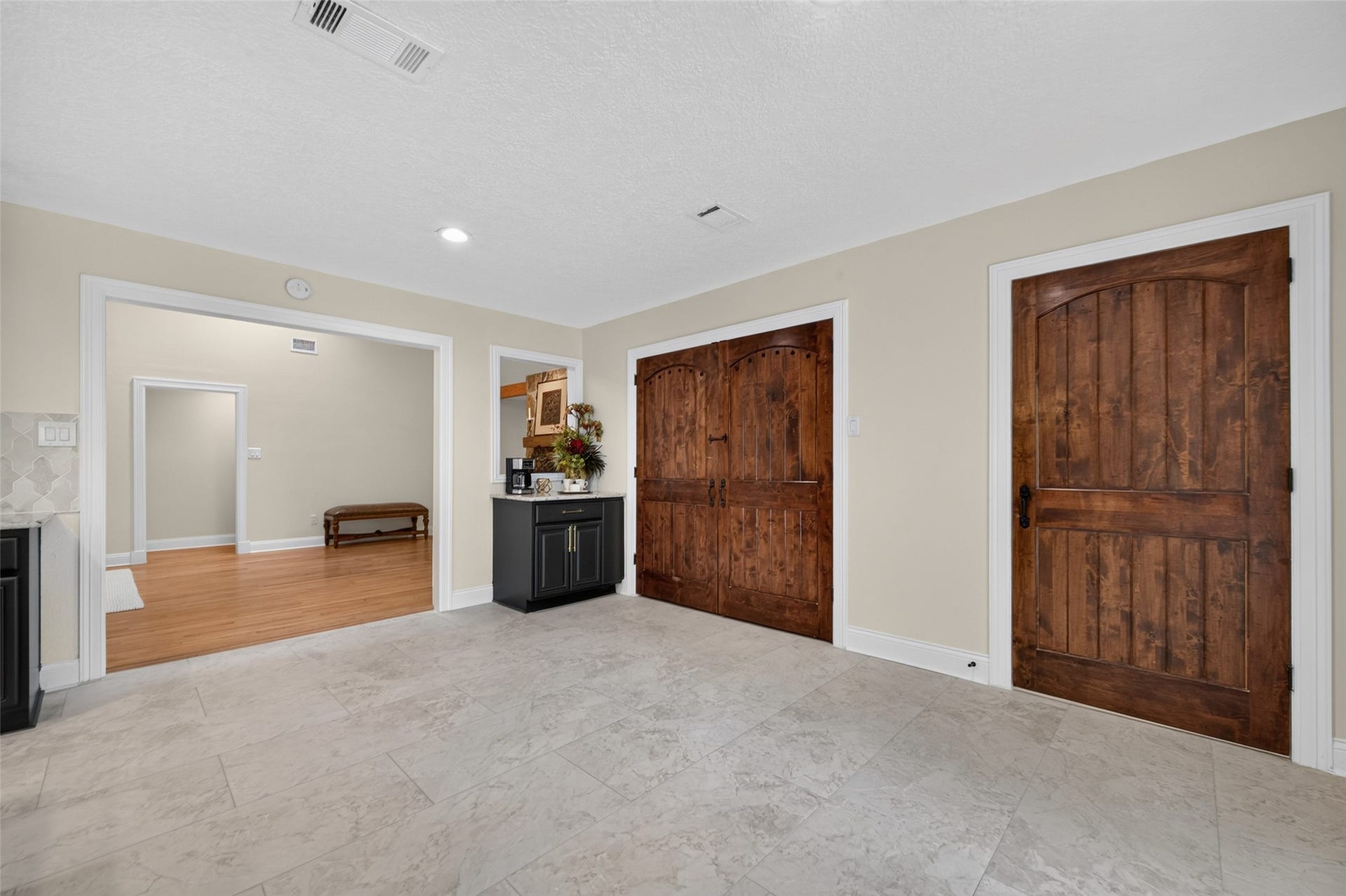 8906 Seber Drive, Tomball, TX 77375 Kitchen flows easily into the main living area with beautiful custom wood doors adding character.