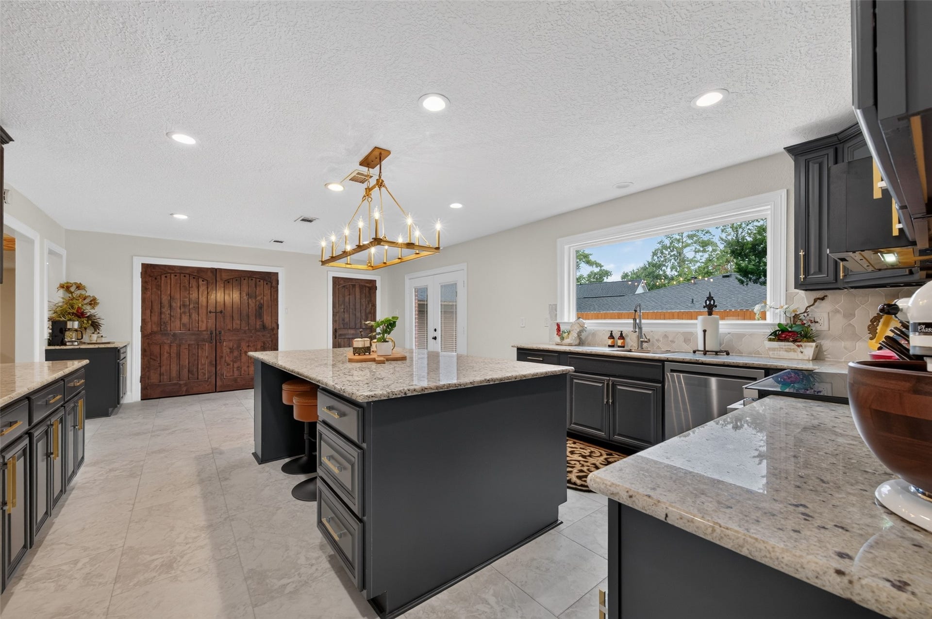8906 Seber Drive, Tomball, TX 77375 Step into the spacious kitchen featuring a large center island and abundant cabinetry.