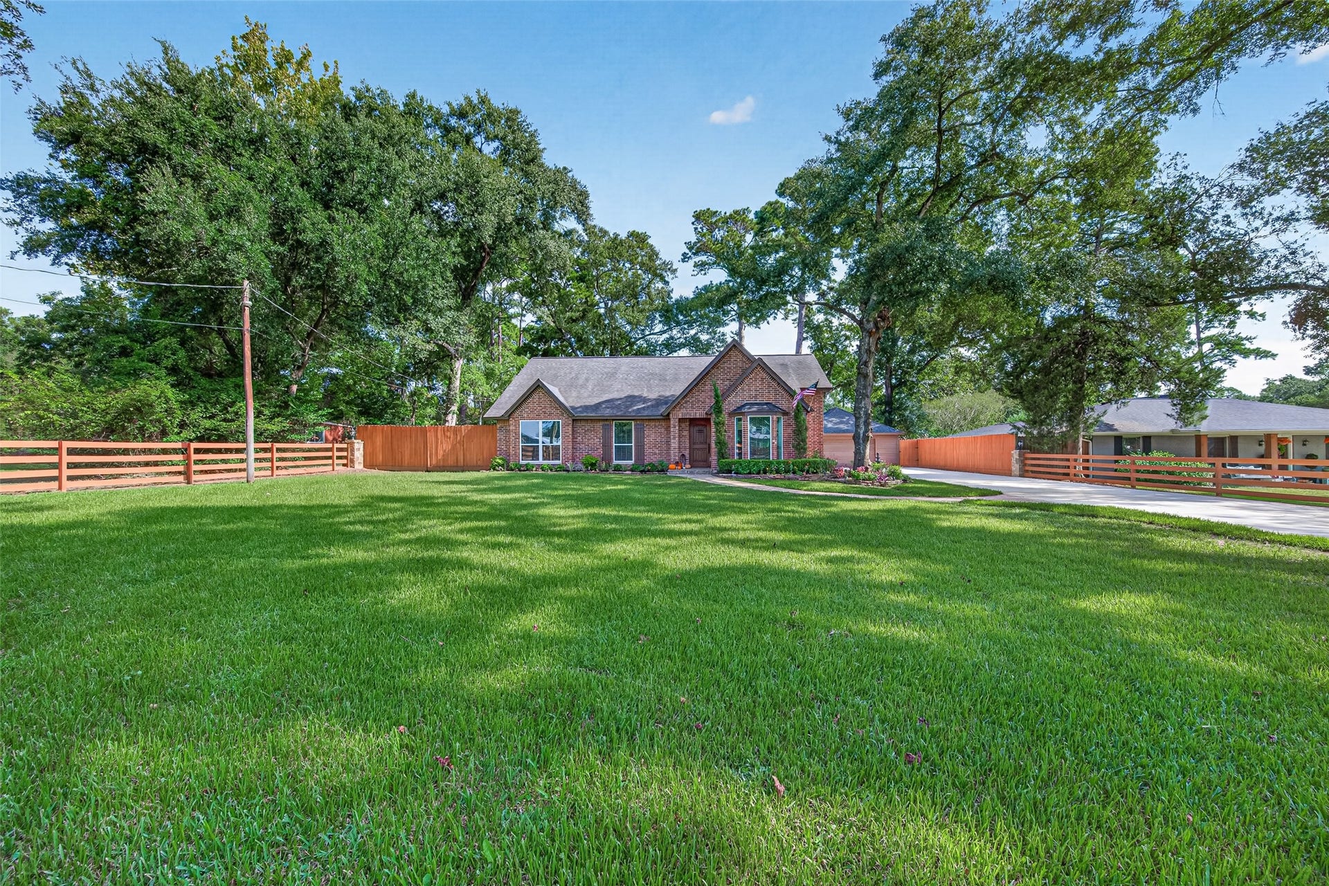 8906 Seber Drive, Tomball, TX 77375 As you make your way up the drive, you get a great view of the home's classic brick exterior, established landscaping and detached garage tucked toward the rear.