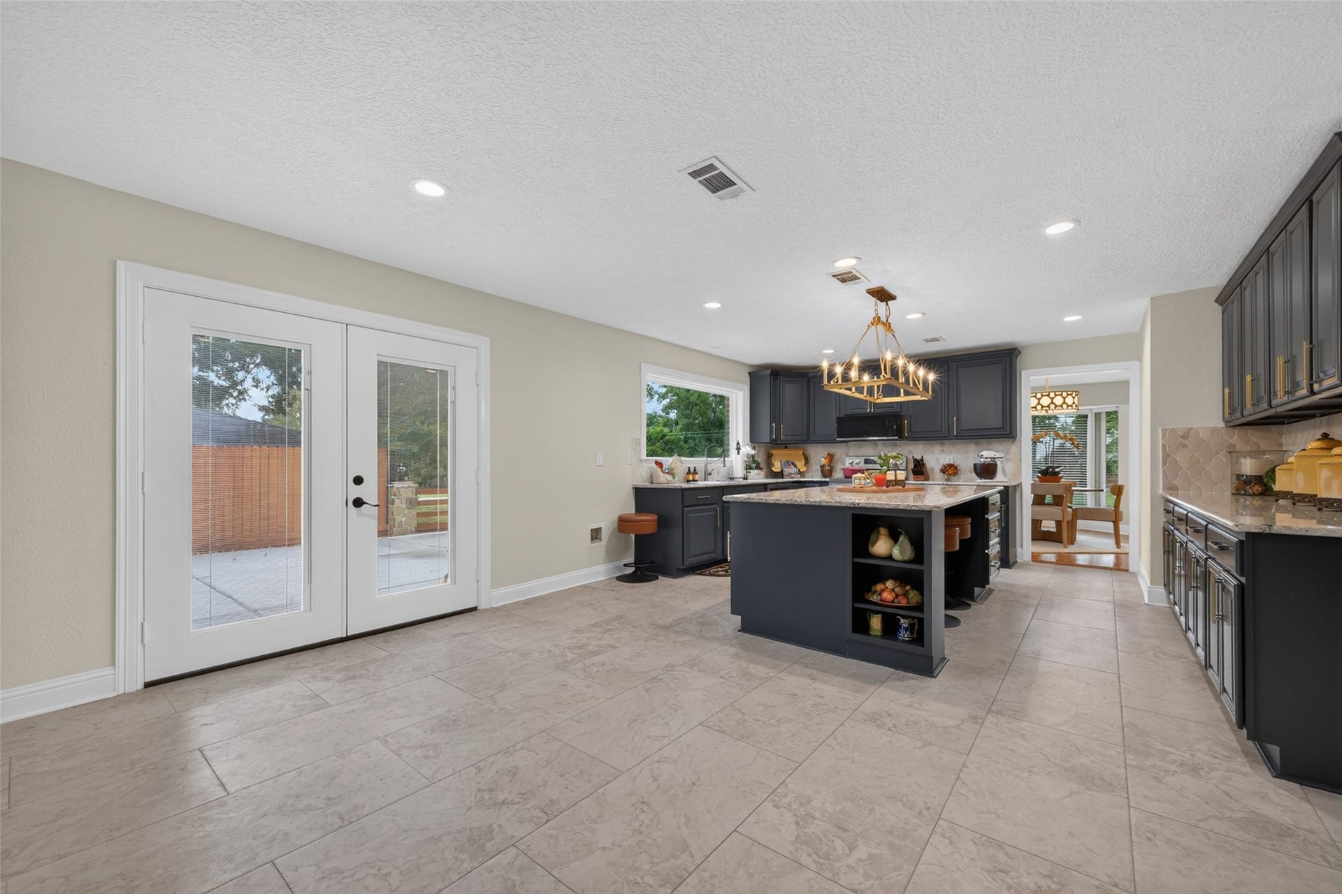 8906 Seber Drive, Tomball, TX 77375 Beyond the island, a large open area offers plenty of space for an oversized dining or breakfast tableperfect for everyday meals or a crowd.