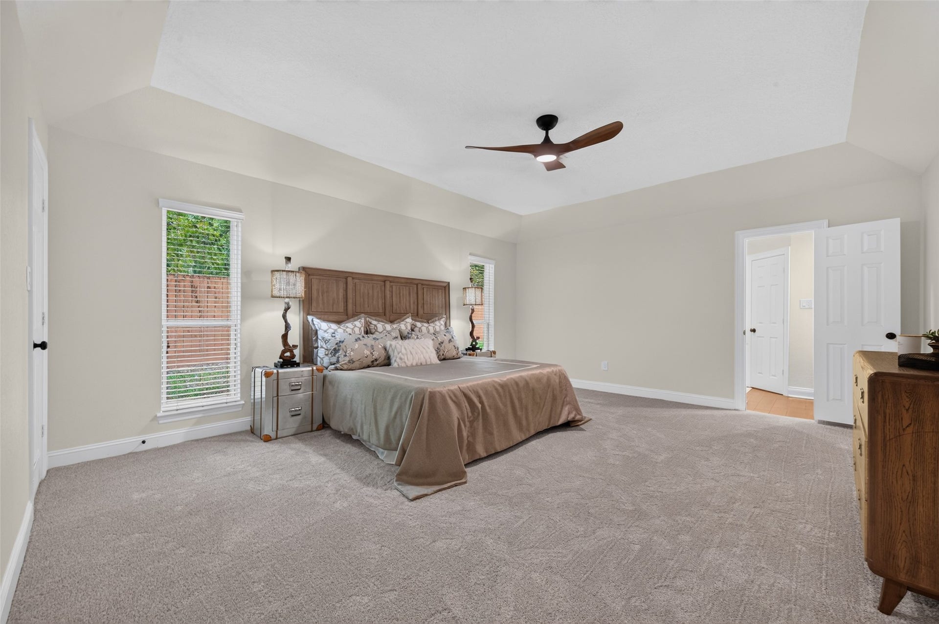 8906 Seber Drive, Tomball, TX 77375 Spacious primary retreat features a tray ceiling, updated ceiling fan and plenty of room for additional furnishings.