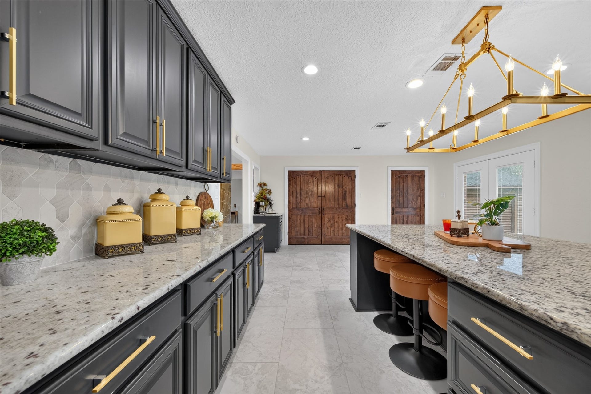 8906 Seber Drive, Tomball, TX 77375 Generous counter space, island seating and stylish finishes make this kitchen ready to gather.