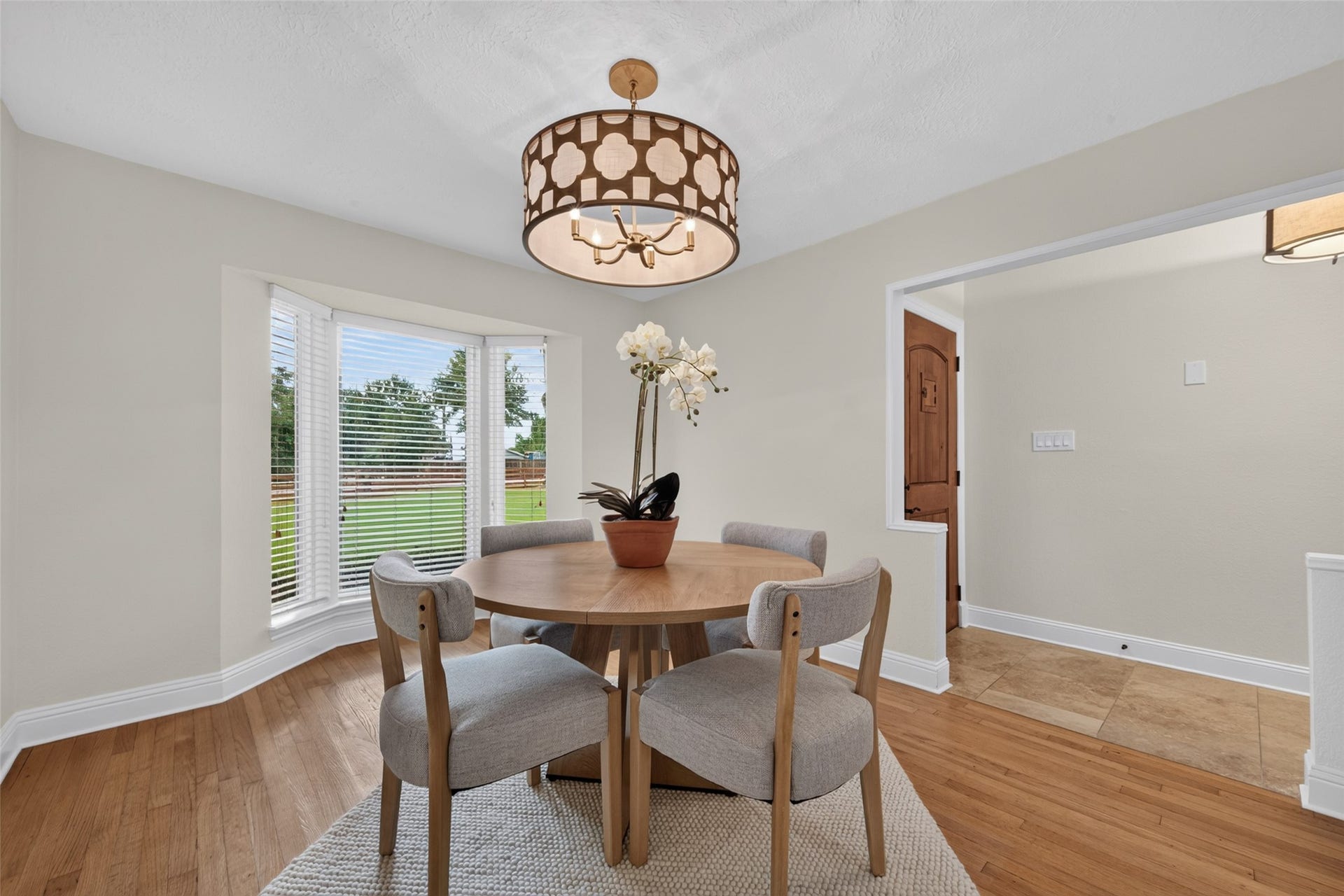 8906 Seber Drive, Tomball, TX 77375 Formal dining room with hardwood floors and a large bay window overlooking the front yard.