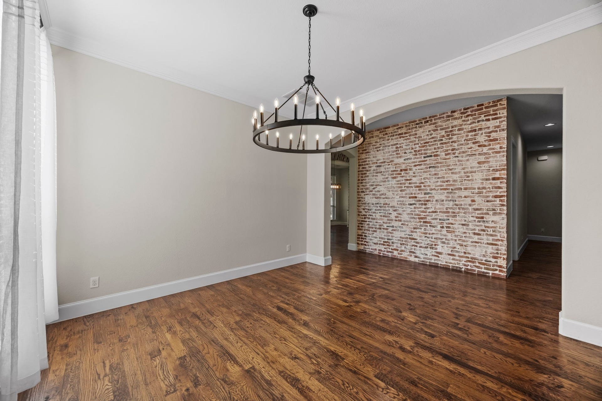 9238 Balsam Gap, Missouri City, TX 77459 View of Dining Room peering into the Hallway highlighted by the brick accent wall.