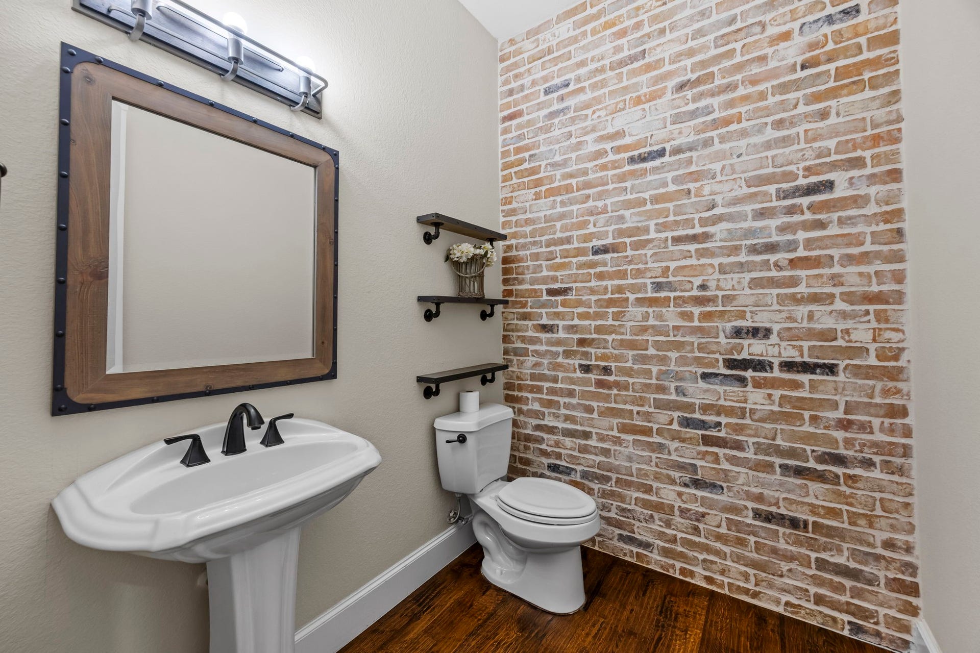 9238 Balsam Gap, Missouri City, TX 77459 Even the hallway half bathroom handsome featuring this brick accent wall