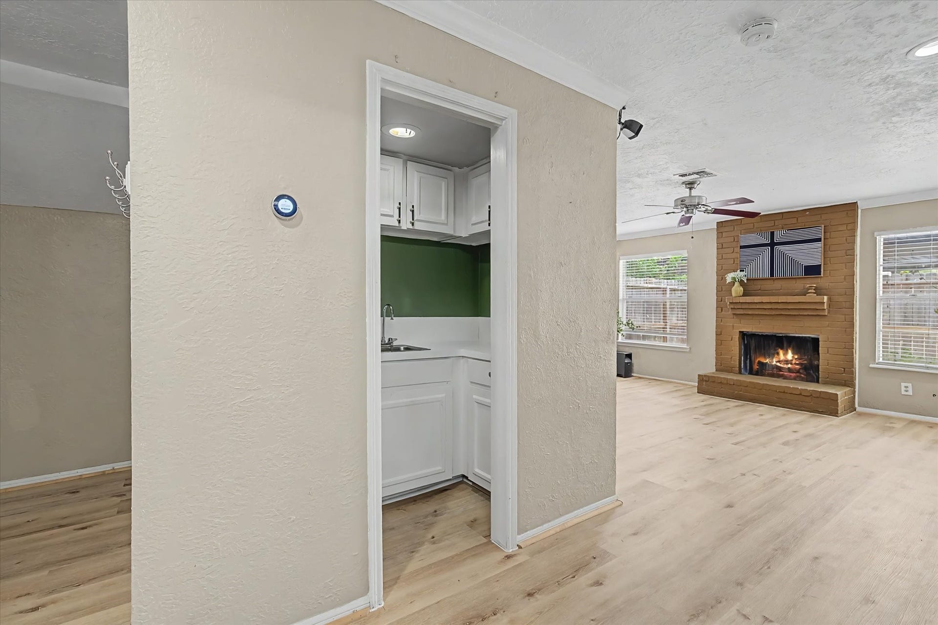 Wide angled view of the hallway leading to the living room.