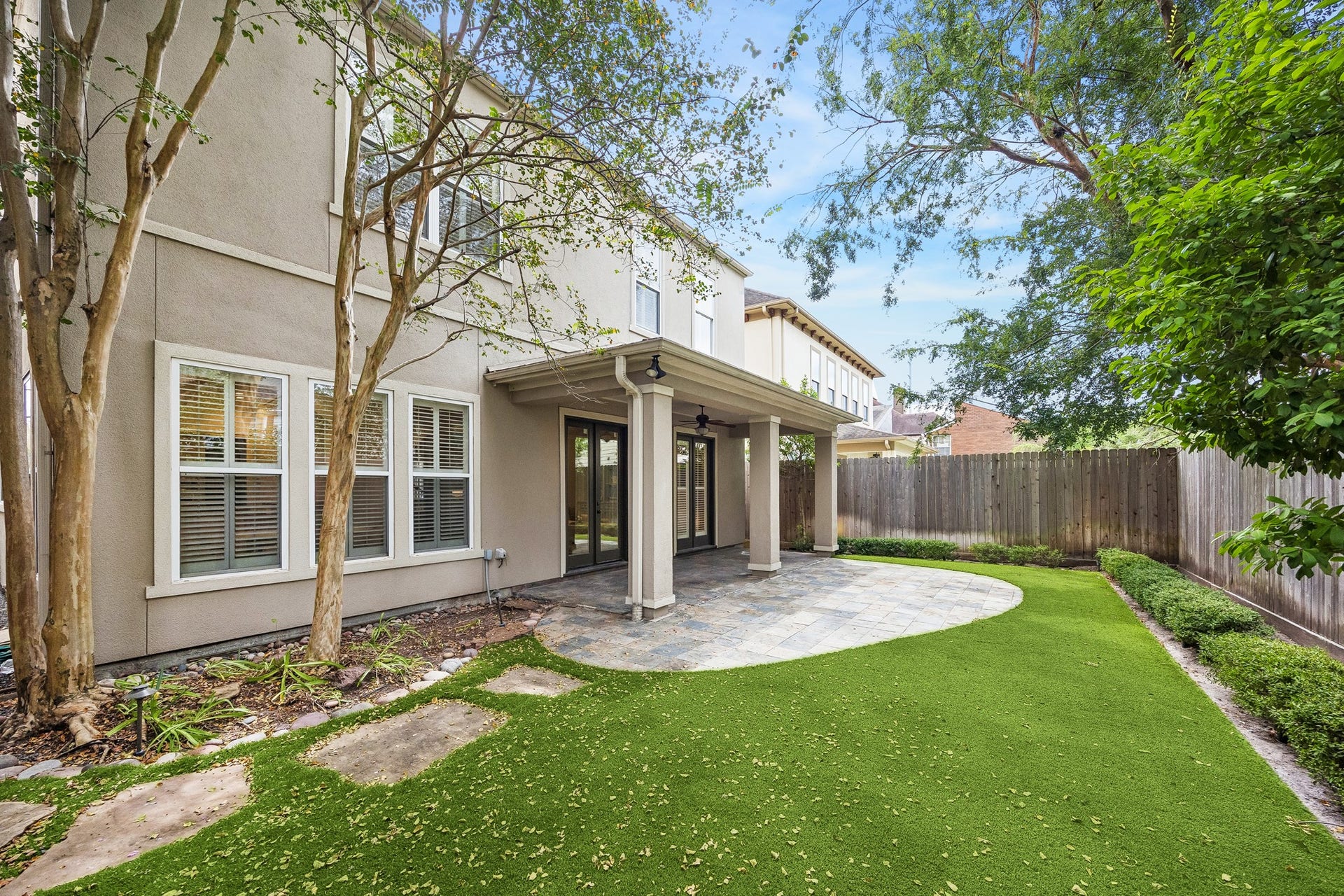 2214 Driscoll Street, Houston, TX 77019 A peek at the beautiful low-maintenance yard space, with covered patio, turf and mature landscaping.