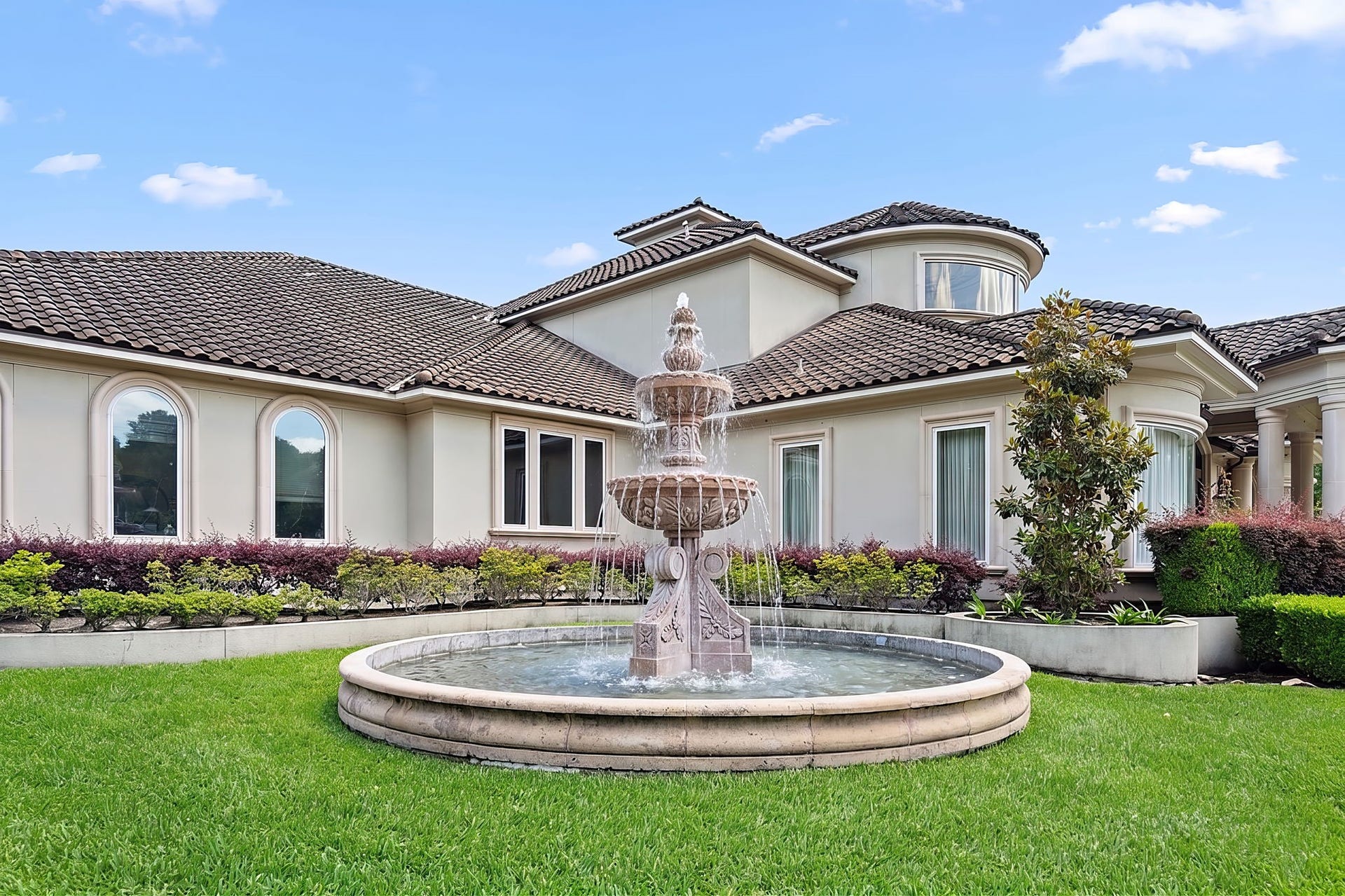 29310 Martelly Way, Huffman, TX 77336 A handcrafted stone fountain welcomes guests with timeless elegance, setting the tone for the exceptional residence beyond.