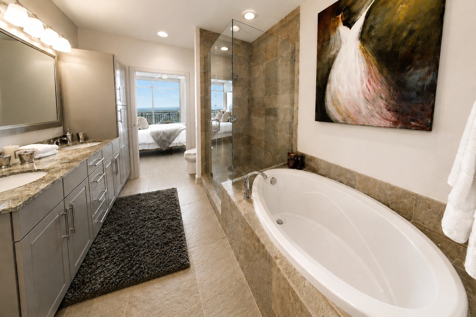 1400 McKinney Street, #2401, Houston, TX 77010 Spacious primary bath with a view! Featuring dual vanities, granite countertops, a soaking tub and separate glass-enclosed shower for a refined, spa-inspired retreat.