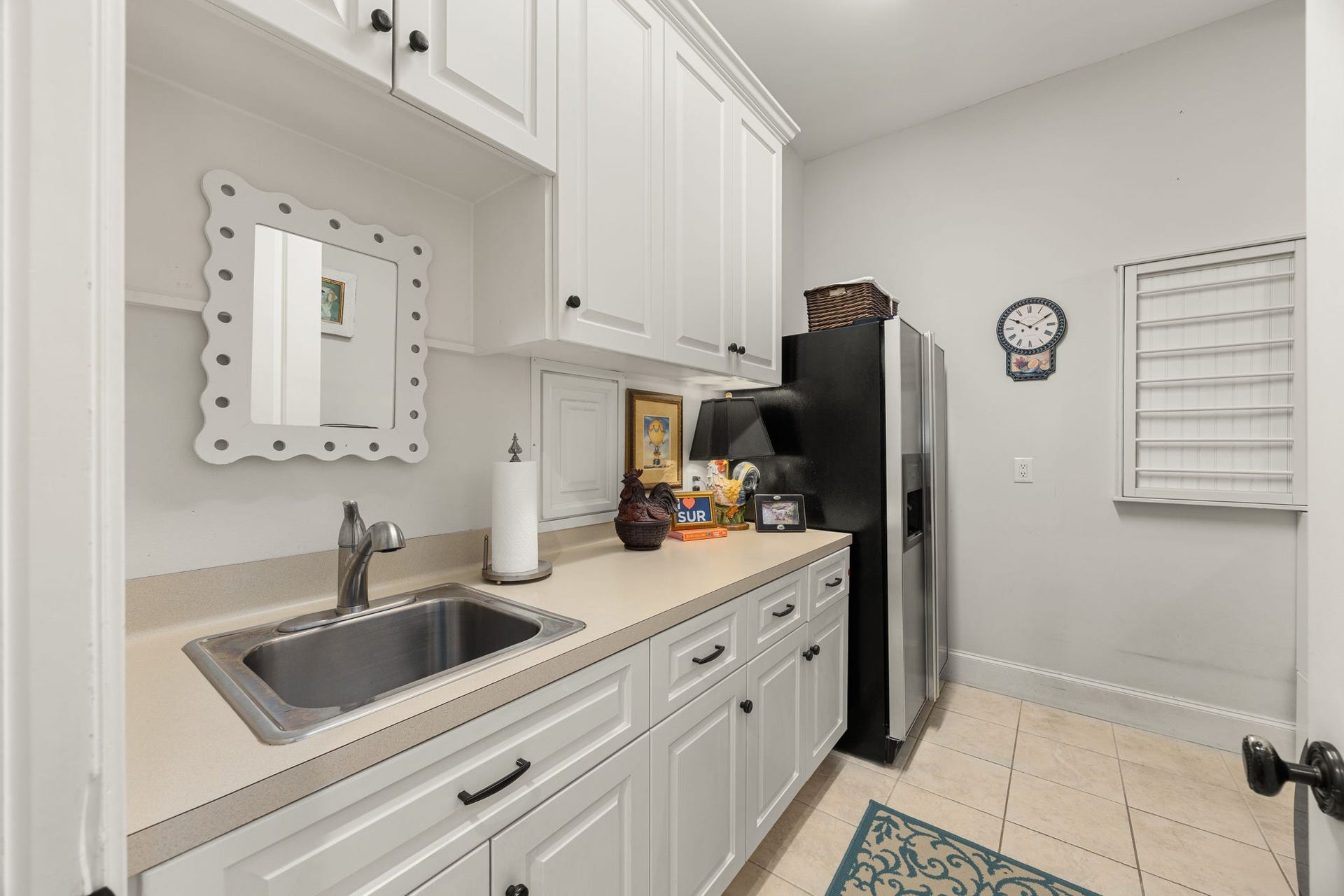 13110 Tosca Lane, Houston, TX 77079 Large laundry room has sink, room for a fridge, drying racks, and lots of storage space.