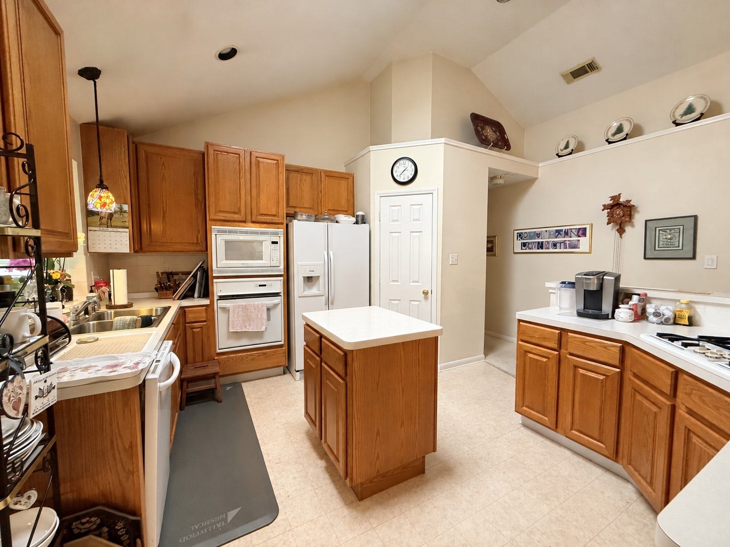 1600 Carriage Run W, Conroe, TX 77384 A Kitchen Designed for Everyday Convenience! This spacious kitchen offers an abundance of cabinetry to keep everything organized and within reach. The center island provides additional storage and valuable countertop space for meal preparation, serving, or simply spreading out while cooking. The sink sits under a sunny window and has a gorgeous pendant light. A practical and functional layout with plenty of room to make this kitchen your own!