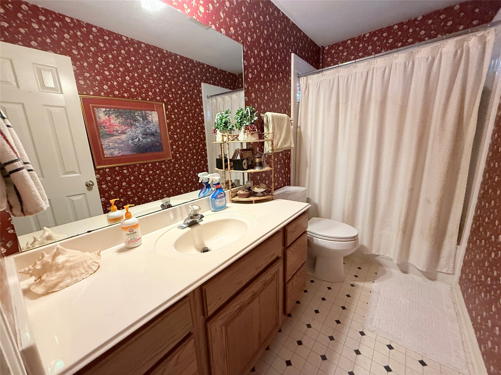 1600 Carriage Run W, Conroe, TX 77384 Convenience & Comfort for Family and Guests! Ideally located to serve Bedroom 3 and visiting guests, this third full bathroom features a single-sink vanity with an extended cultured marble countertop, providing plenty of space for everyday essentials. A tiled tub/shower combination offers versatility, while the convenient hallway location makes this bath easily accessible to everyone!