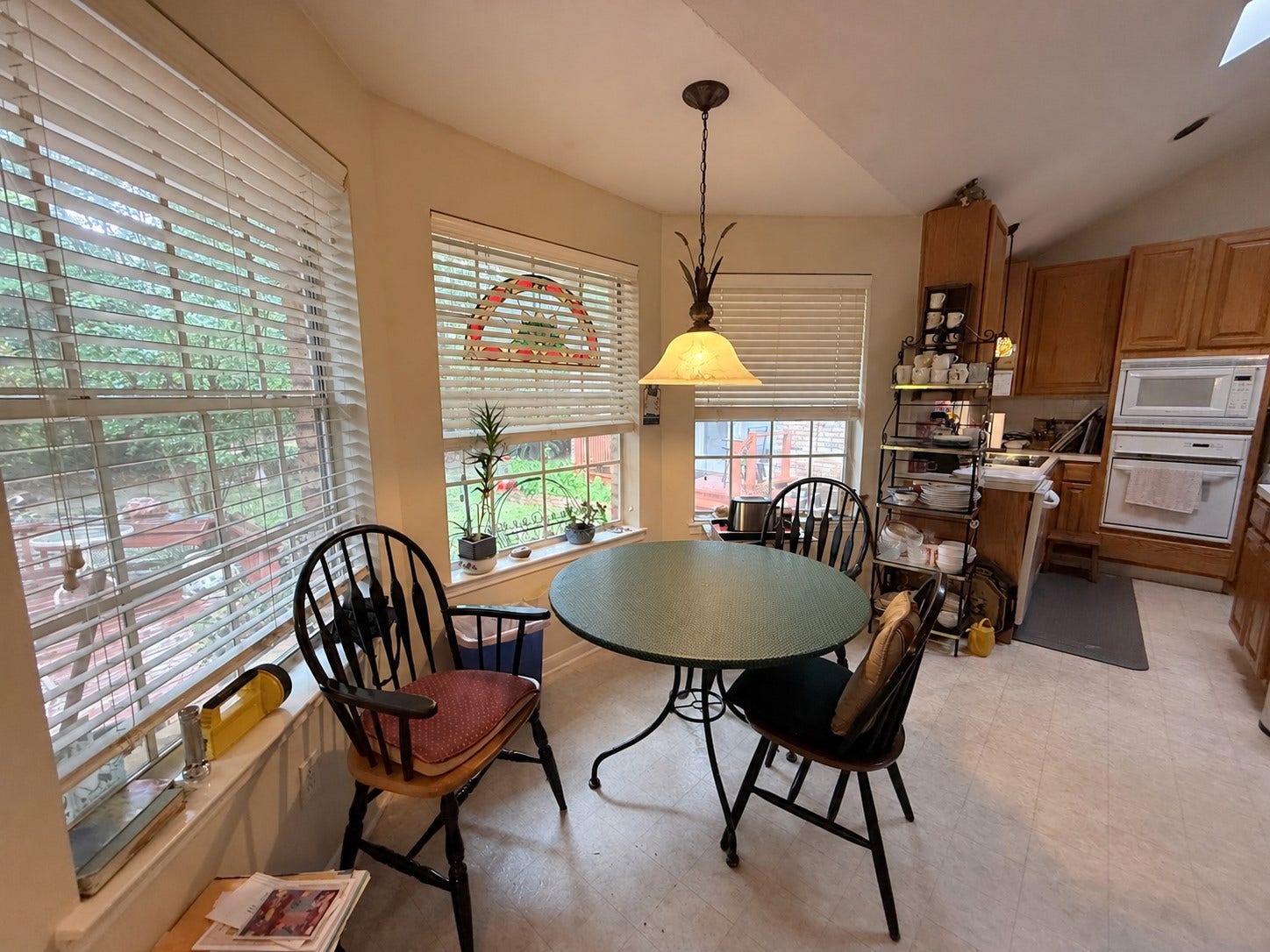 1600 Carriage Run W, Conroe, TX 77384 Sunny Mornings & Scenic Views! Bathed in natural light from an abundance of windows, this cheerful breakfast area features tile flooring and a lovely chandelier that adds a touch of charm. Convenient access to the expansive outdoor deck makes it easy to take your morning coffee outside, enjoy the peaceful wooded surroundings, or extend your dining experience into the fresh air!