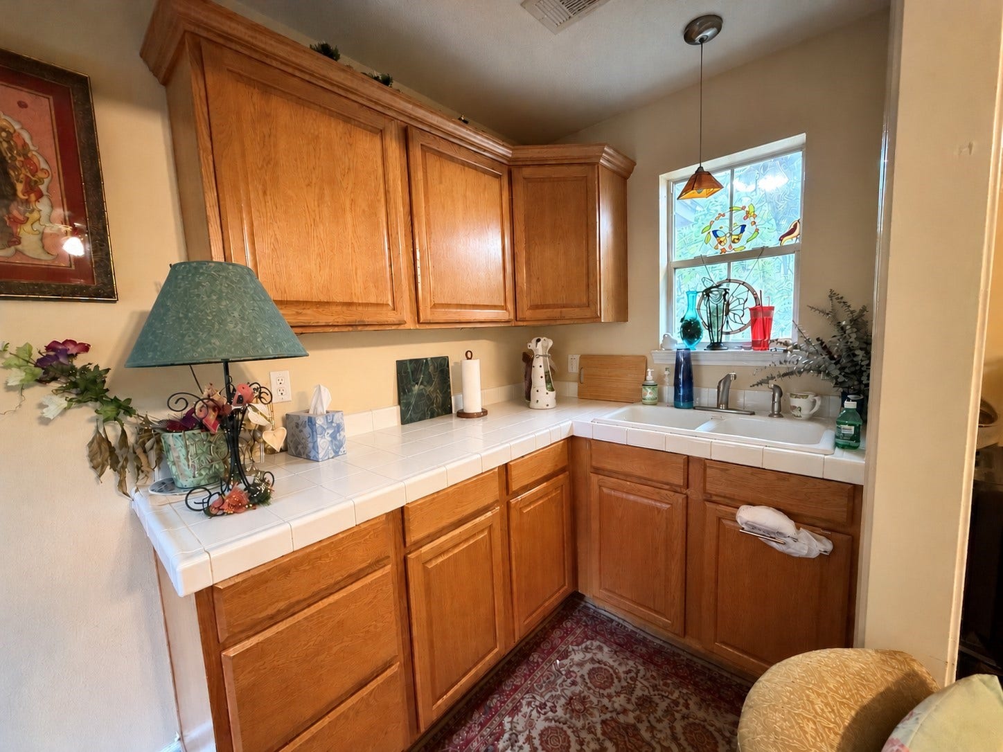 1600 Carriage Run W, Conroe, TX 77384 A Private Kitchenette Adds Endless Possibilities! Conveniently positioned between the second bedroom and an expansive sitting area/media room, this charming kitchenette features tile countertops, a sink, and a sunny window that welcomes natural light. Imagine the convenience of your own morning coffee station in a second primary suite, or the added independence and privacy it provides for extended-stay guests. A thoughtful feature that makes this versatile living space even more appealing!